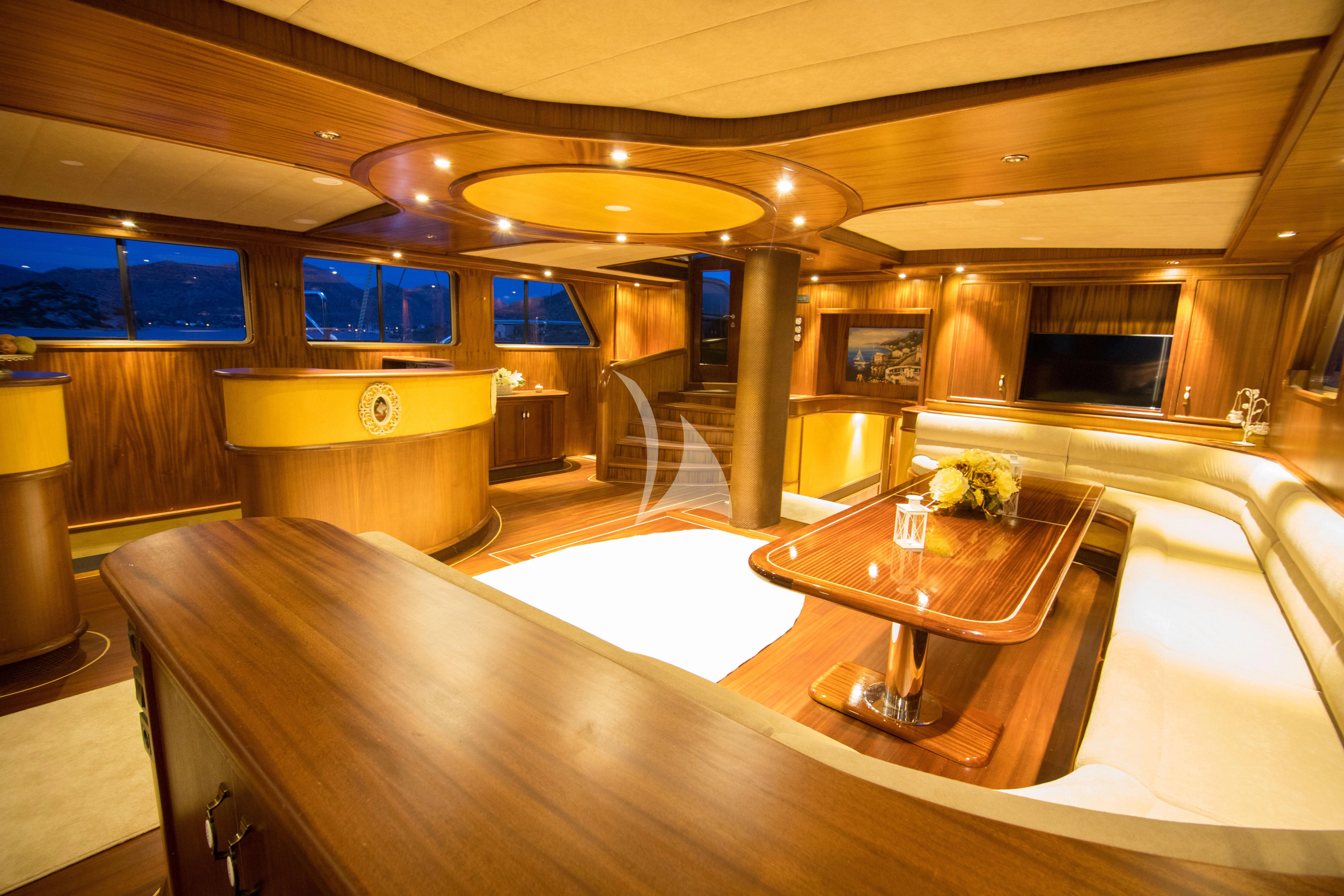 a large room with a table and chairs aboard NEVRA QUEEN Yacht for Sale
