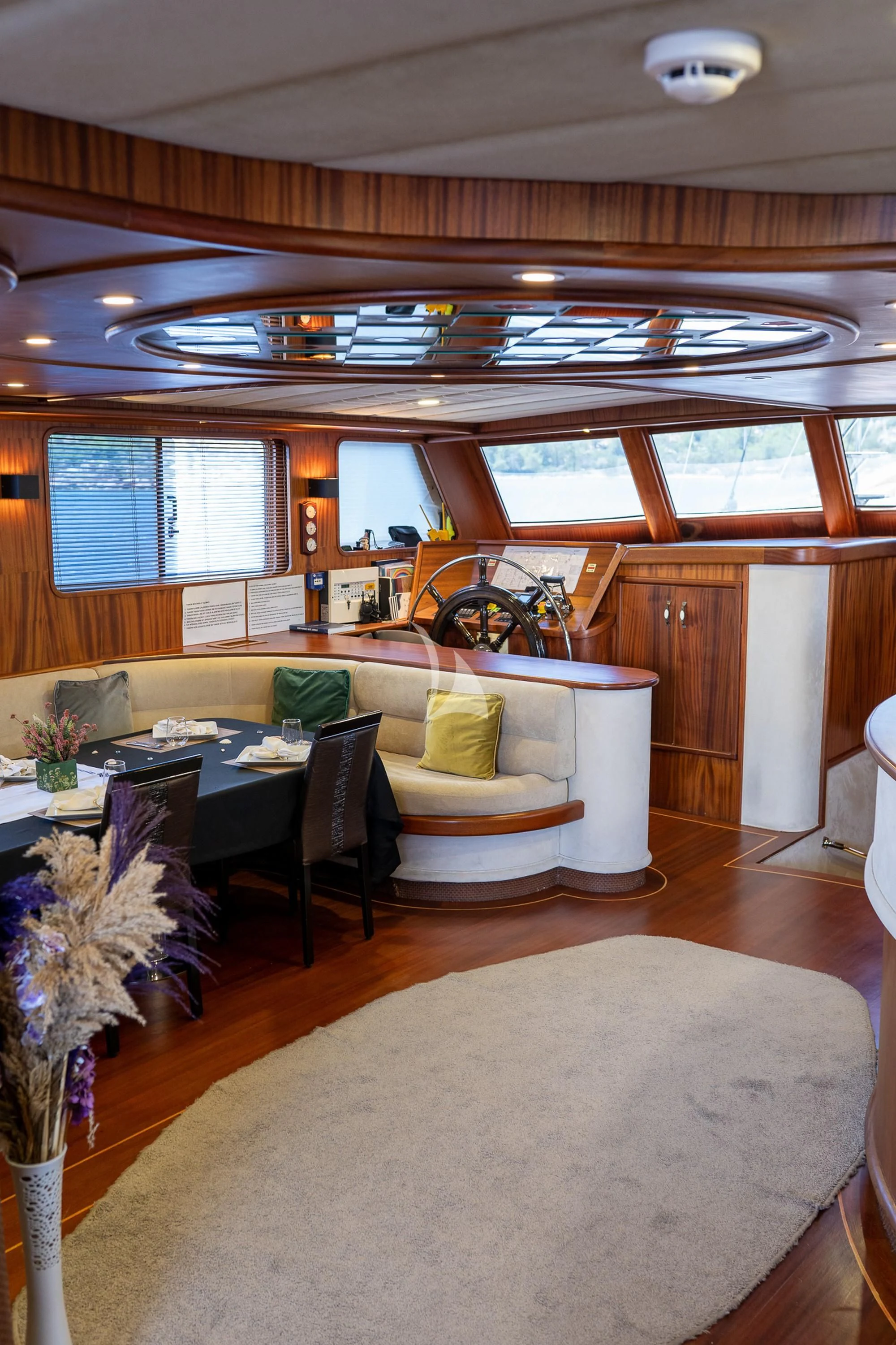 a living room with a large table and chairs aboard NEVRA QUEEN Yacht for Sale
