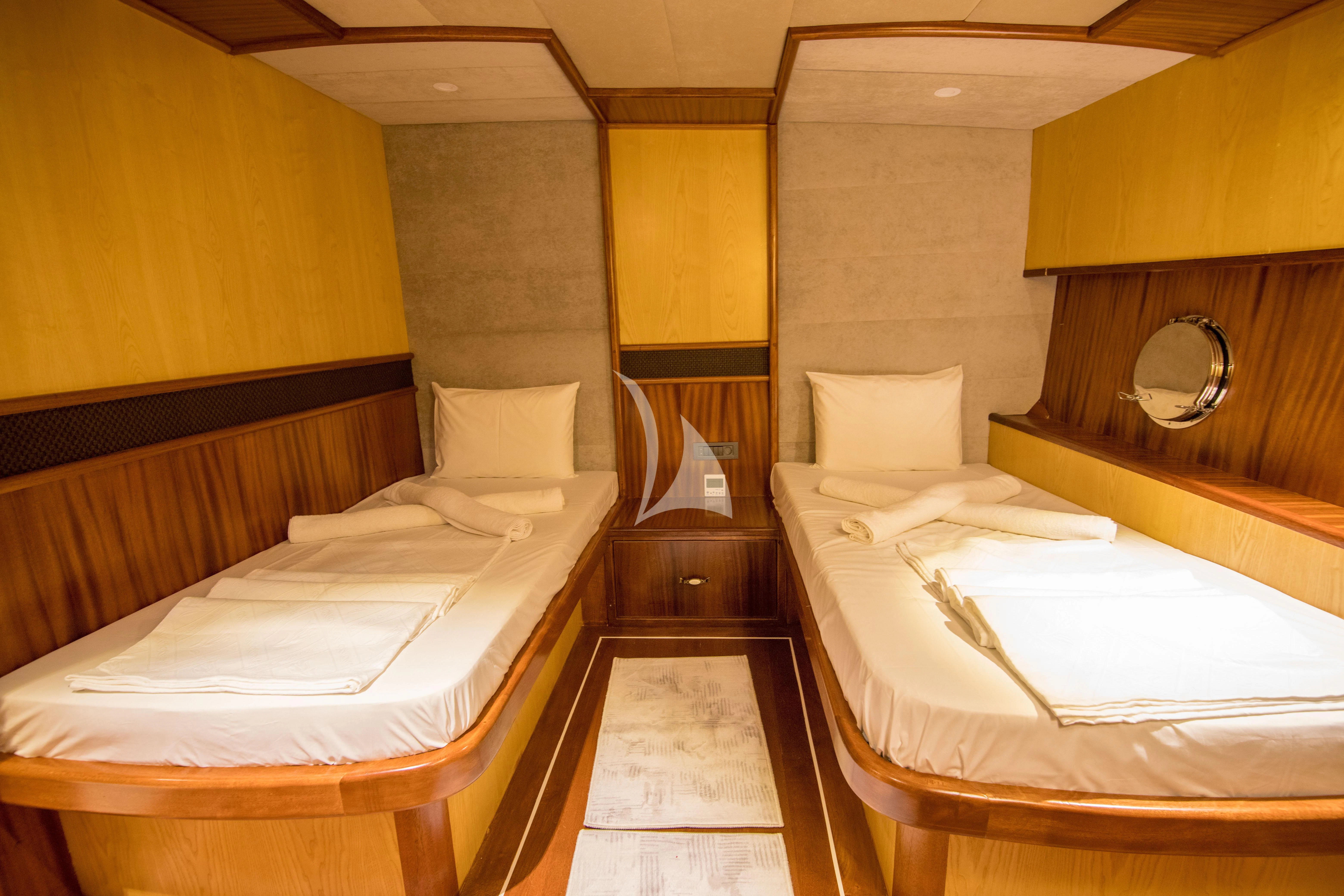 a room with beds and a mirror aboard NEVRA QUEEN Yacht for Sale