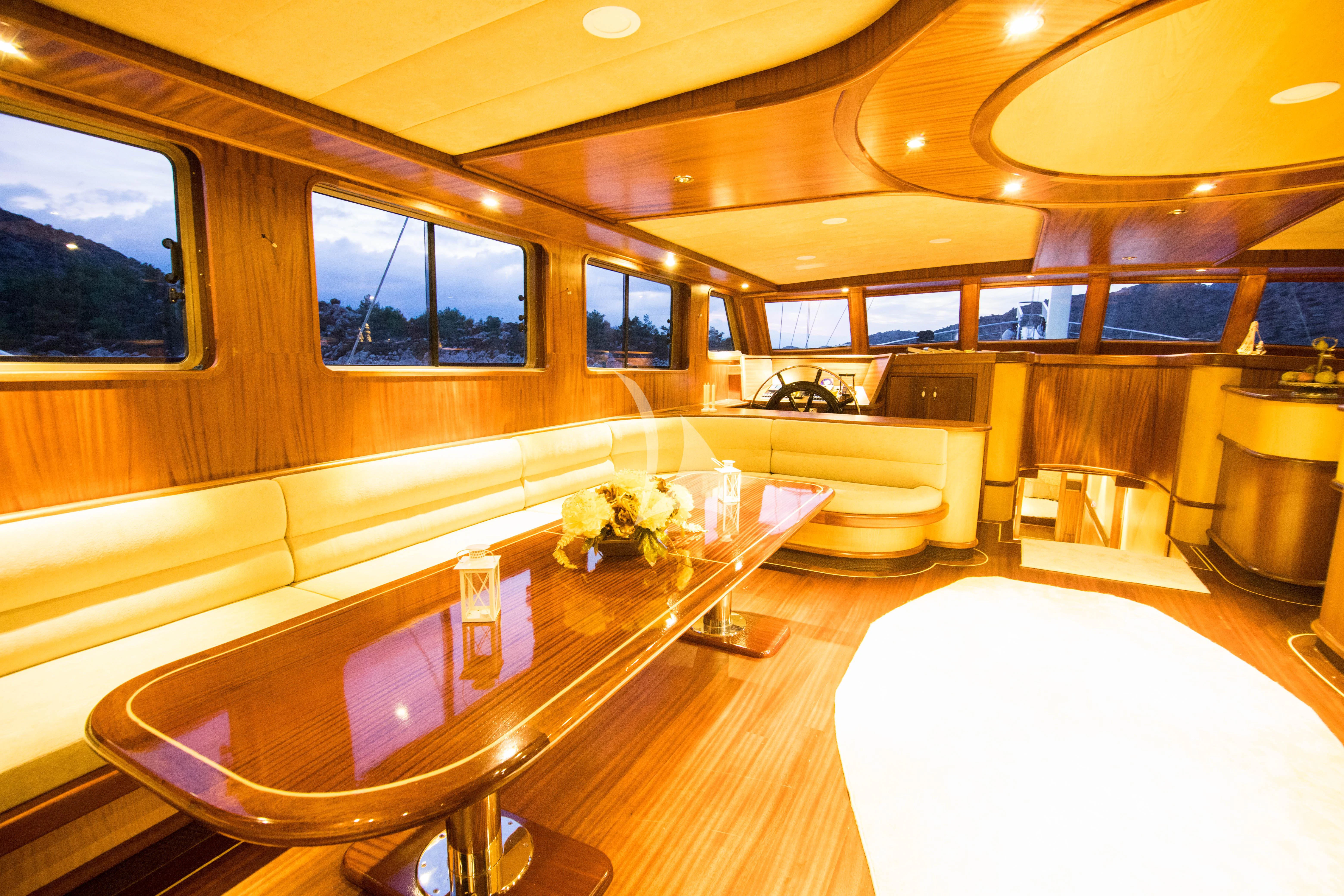 a large room with a table and chairs aboard NEVRA QUEEN Yacht for Sale