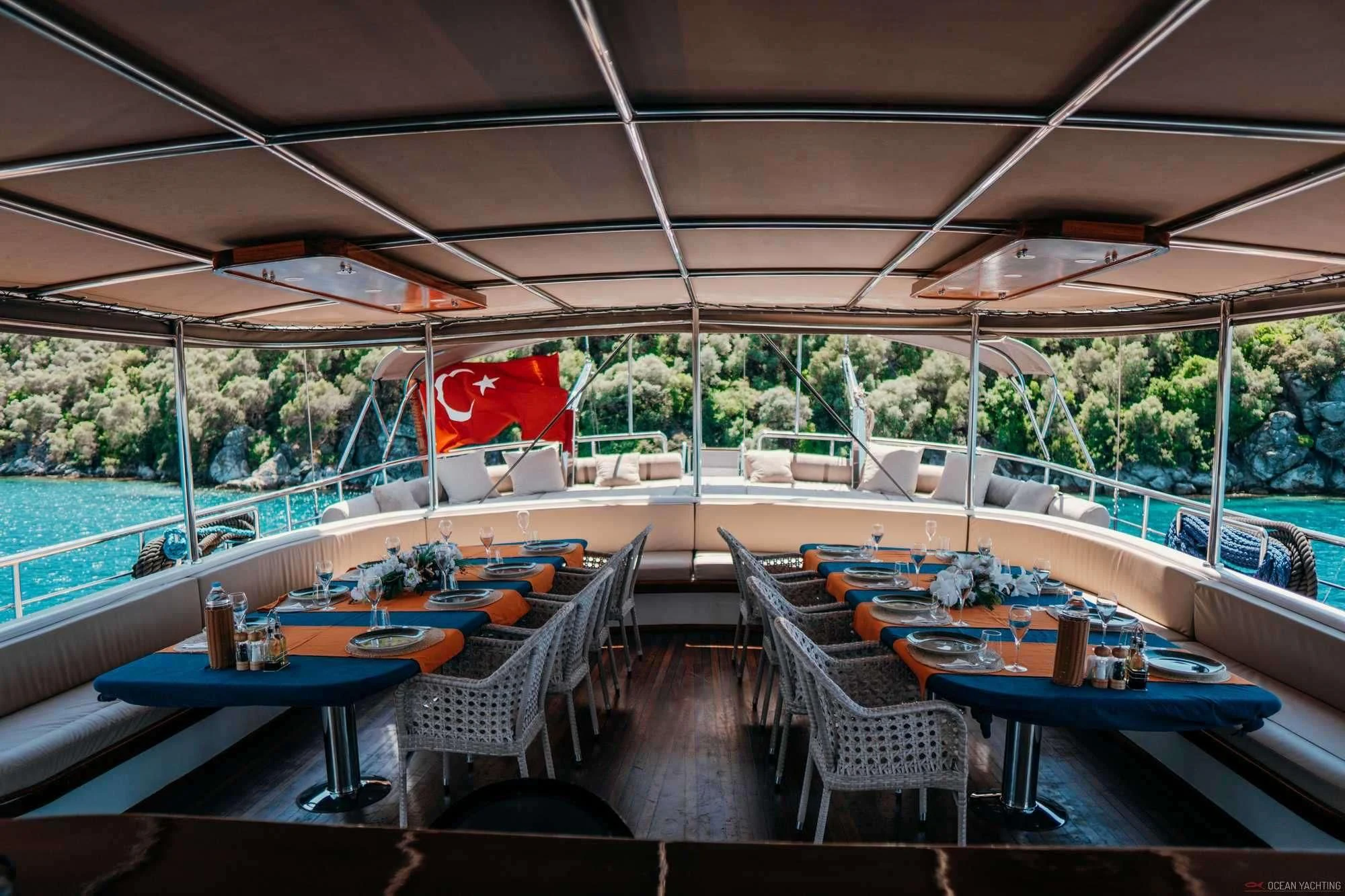 a patio with tables and chairs aboard NEVRA QUEEN Yacht for Sale