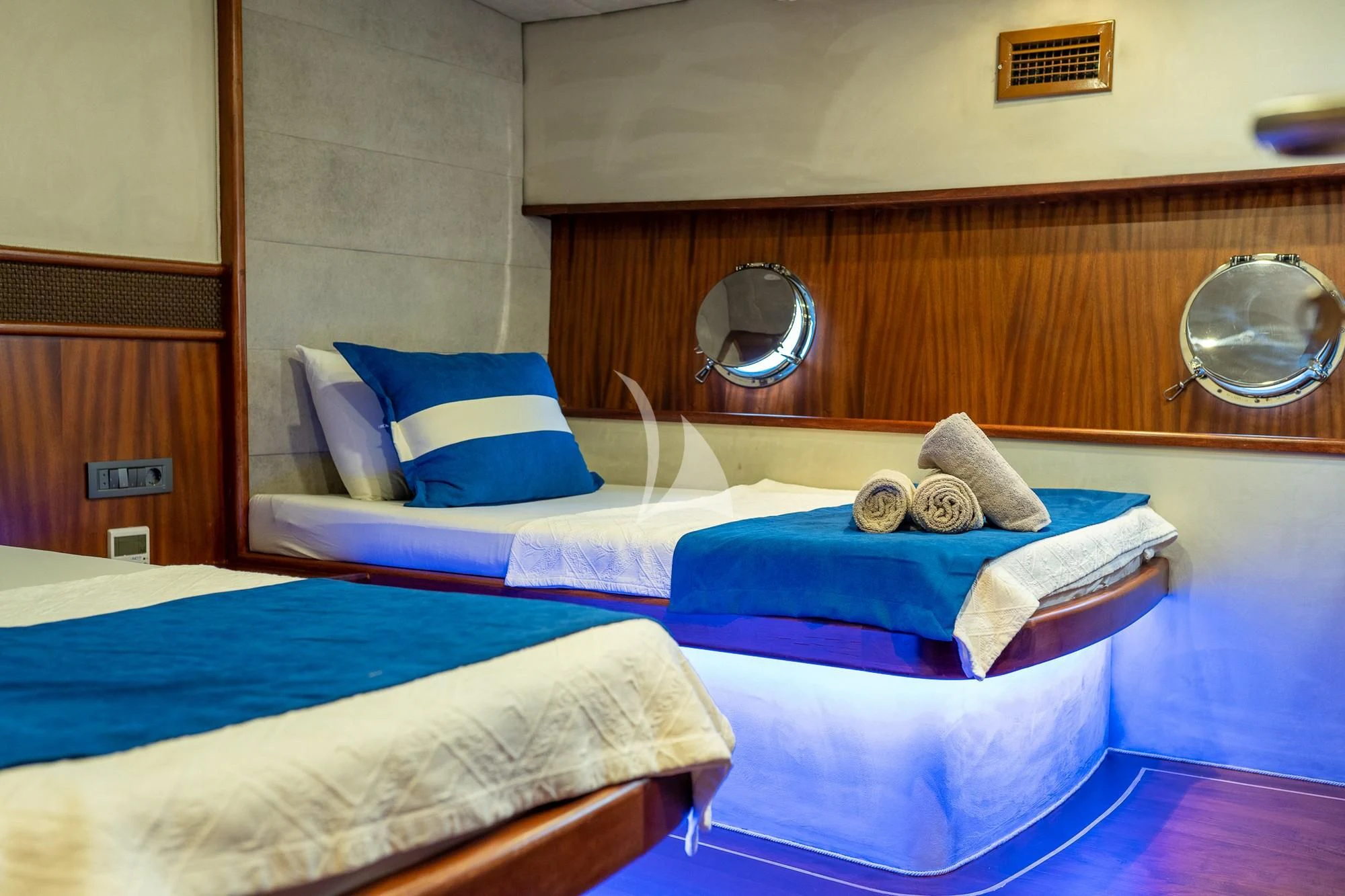 a bed with blue sheets aboard NEVRA QUEEN Yacht for Sale