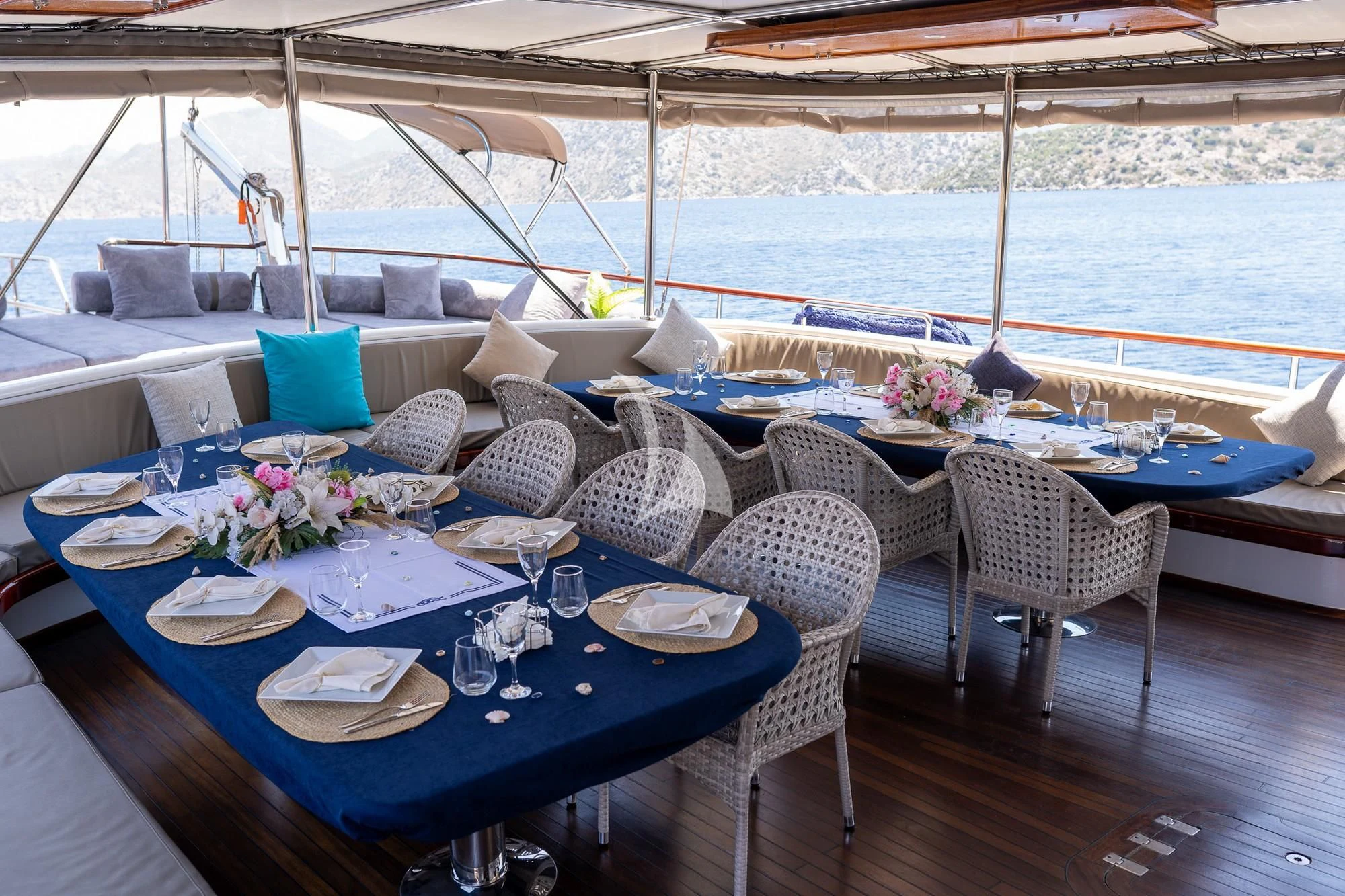 a table set for a meal on a deck aboard NEVRA QUEEN Yacht for Sale