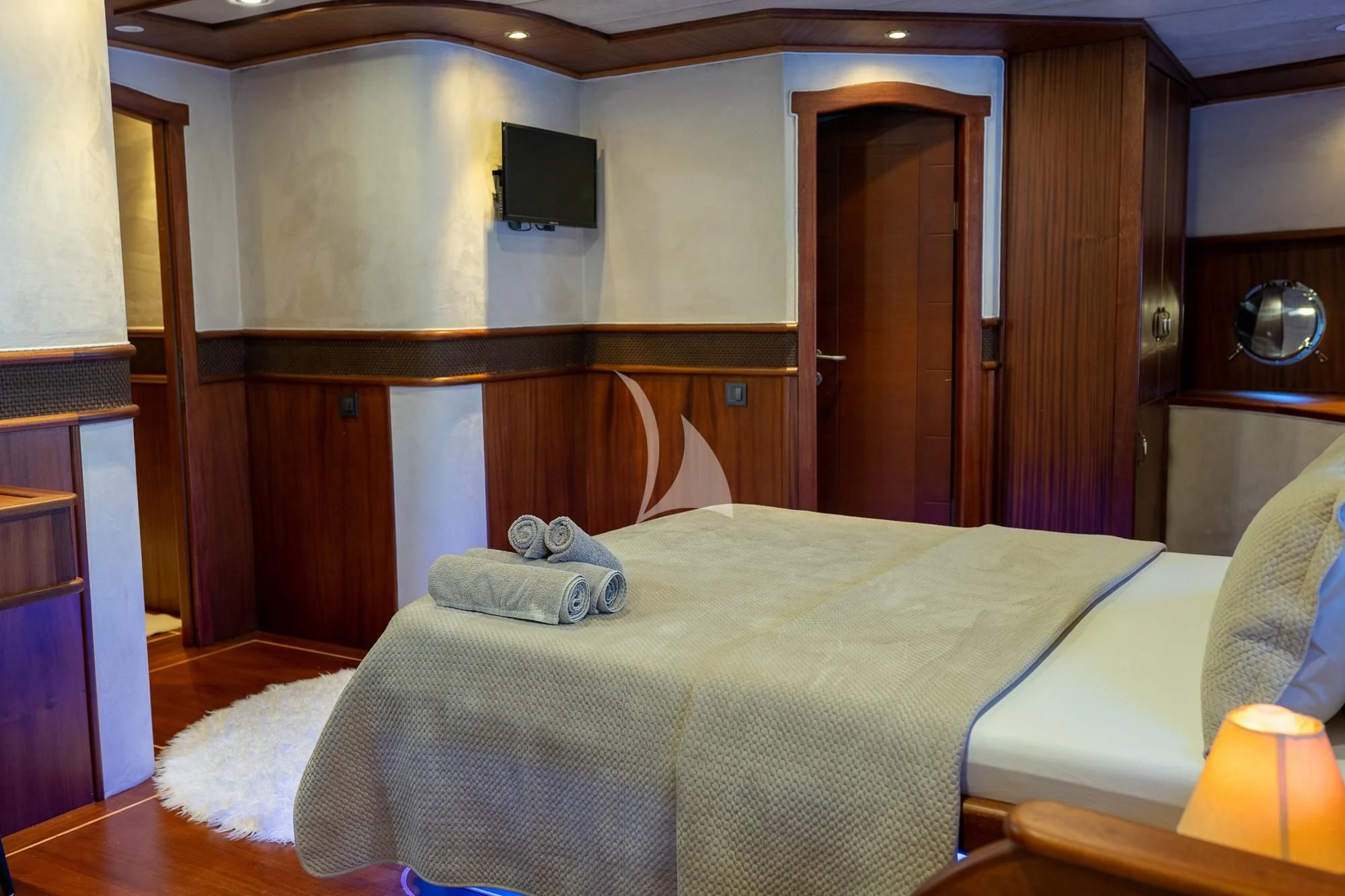 a bedroom with a bed and a television aboard NEVRA QUEEN Yacht for Sale