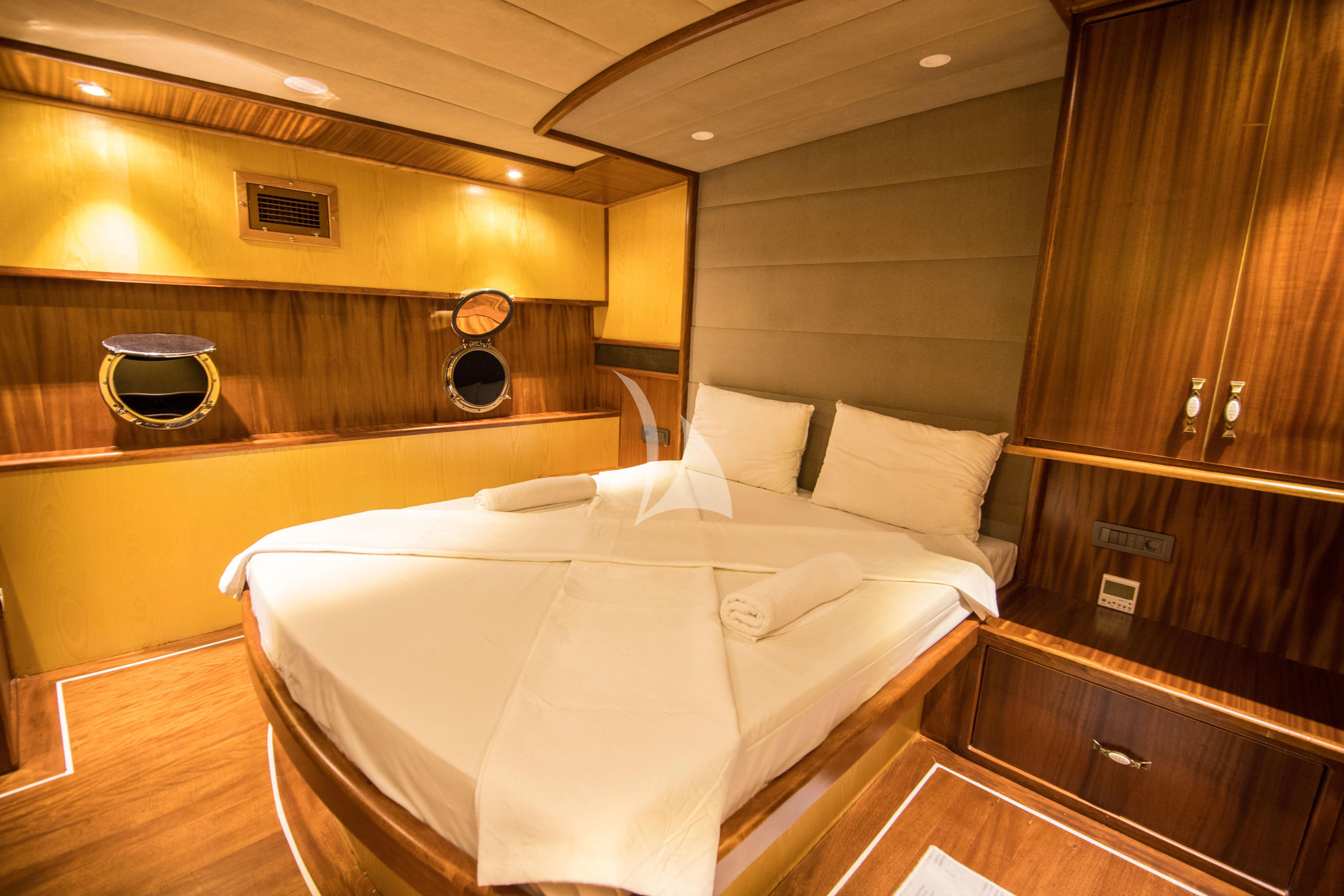 a large bed in a room aboard NEVRA QUEEN Yacht for Sale