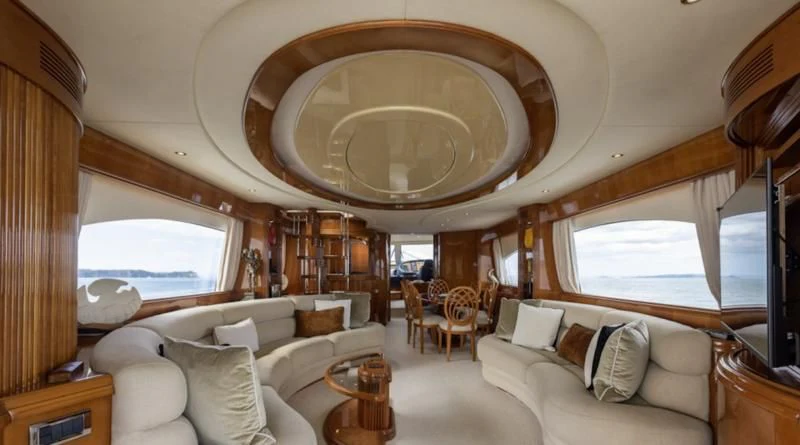 a large room with a couch and a large mirror aboard INTEGRITY Yacht for Sale