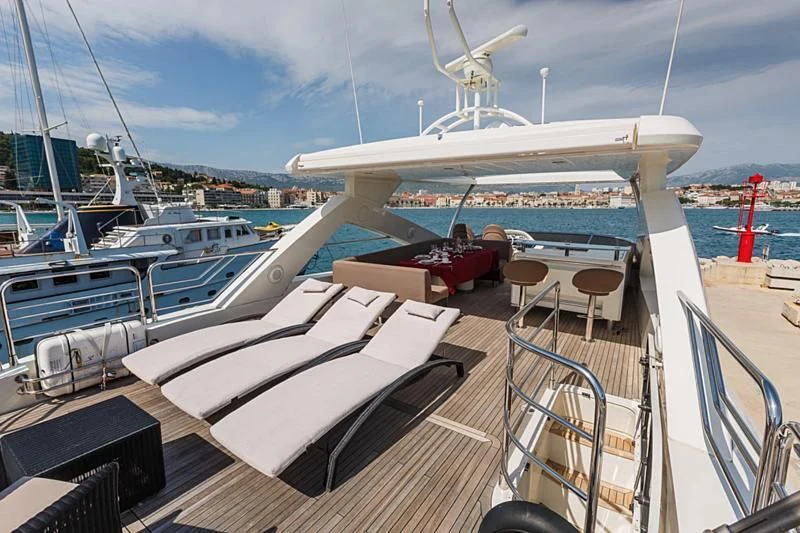 a deck with a boat and chairs on it aboard THE BEST WAY Yacht for Sale