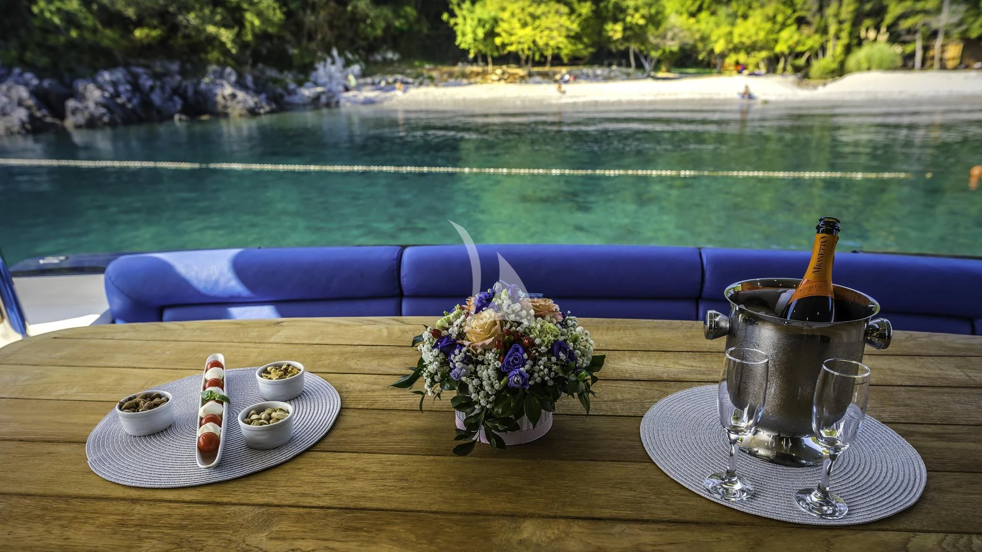 a table with a plate of food and a bottle of wine on it aboard THE BEST WAY Yacht for Sale