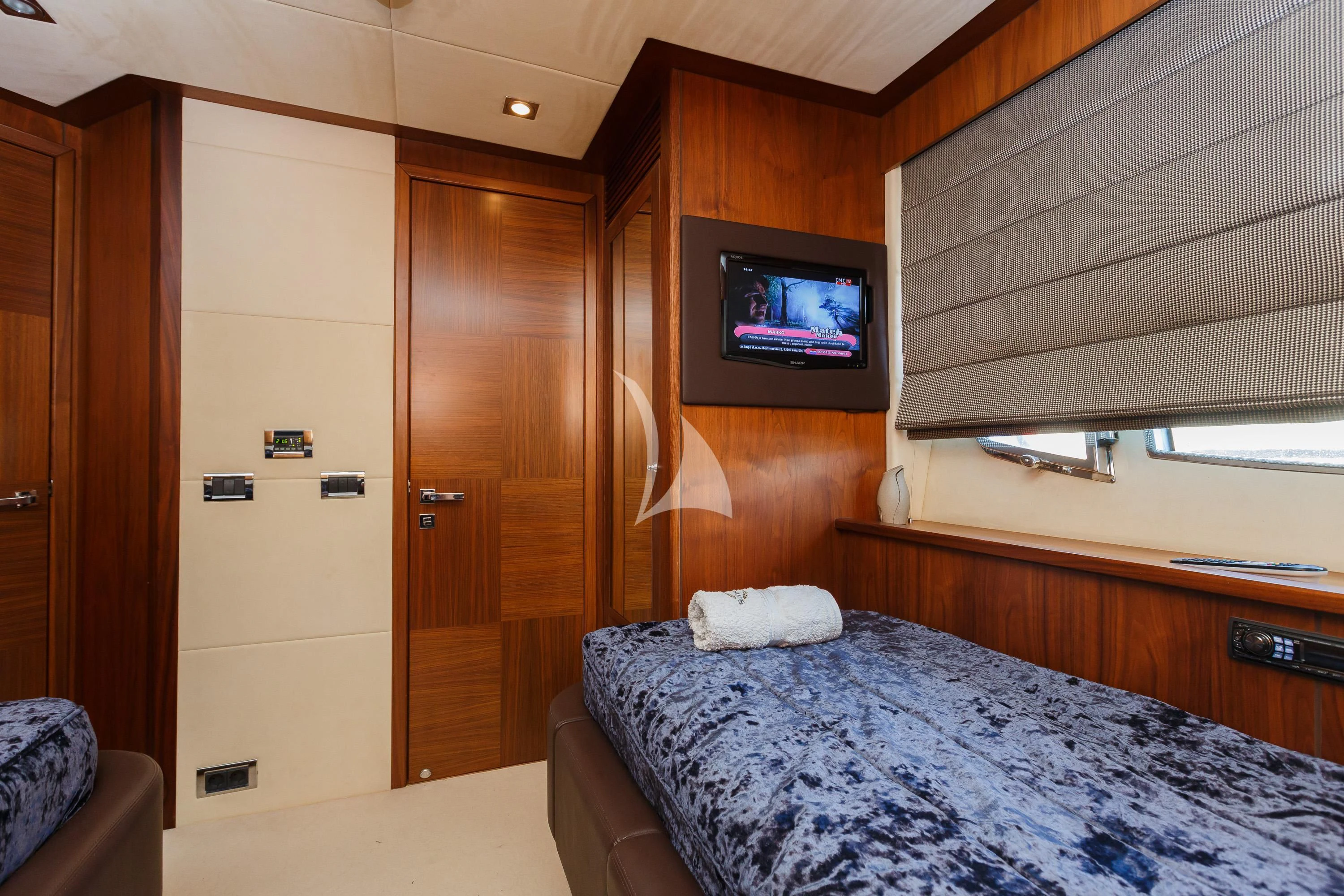 a bedroom with a bed and tv aboard THE BEST WAY Yacht for Sale