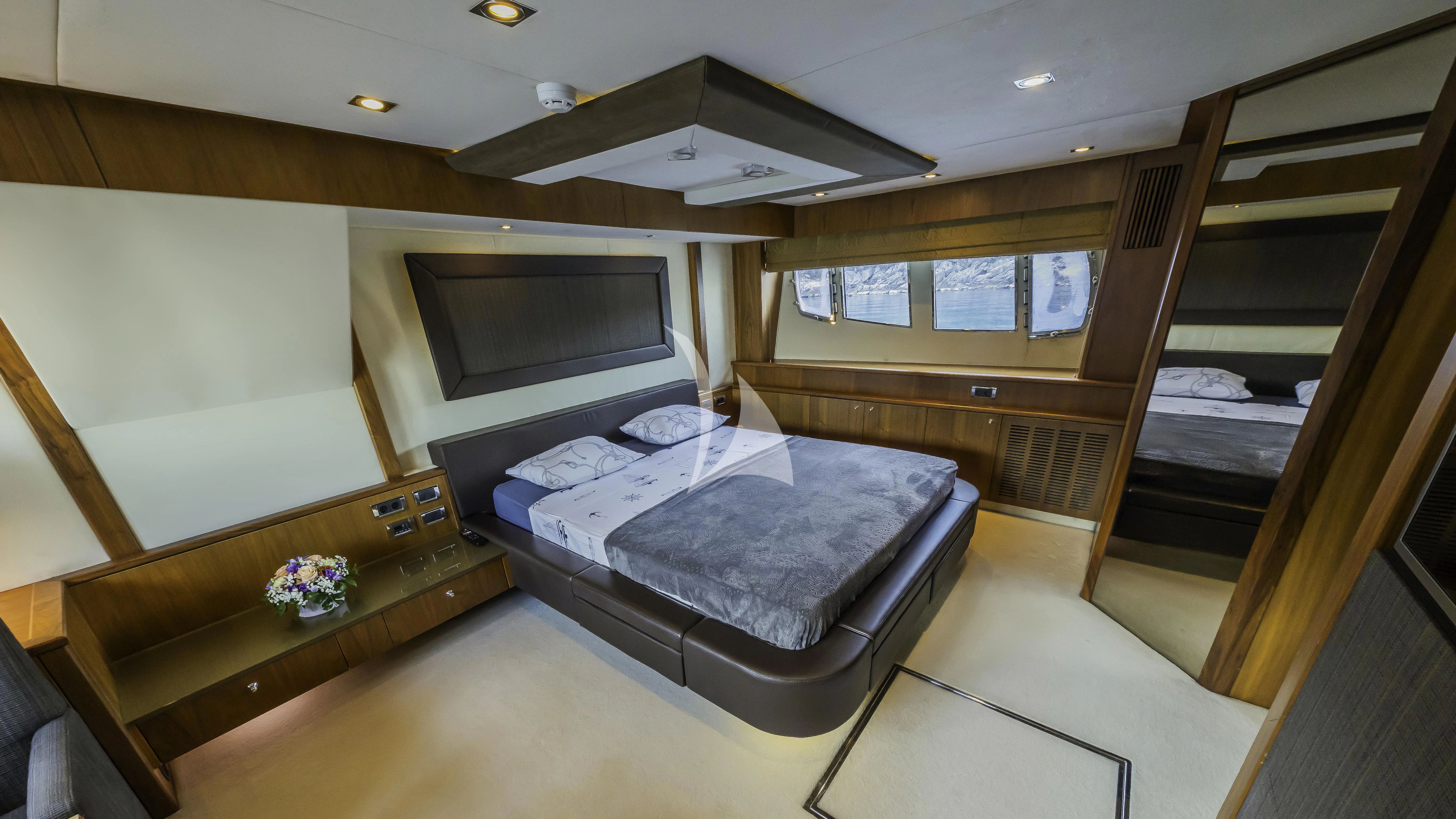 a bedroom with a bed and a tv aboard THE BEST WAY Yacht for Sale