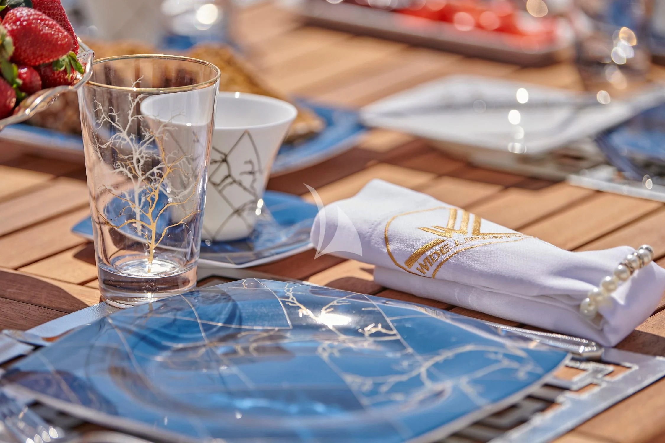 a glass of water and a napkin on a table aboard WIDE LIBERTY Yacht for Sale