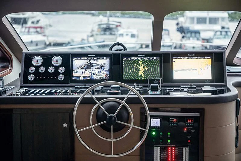 a control panel with a computer and other monitors aboard WIDE LIBERTY Yacht for Sale