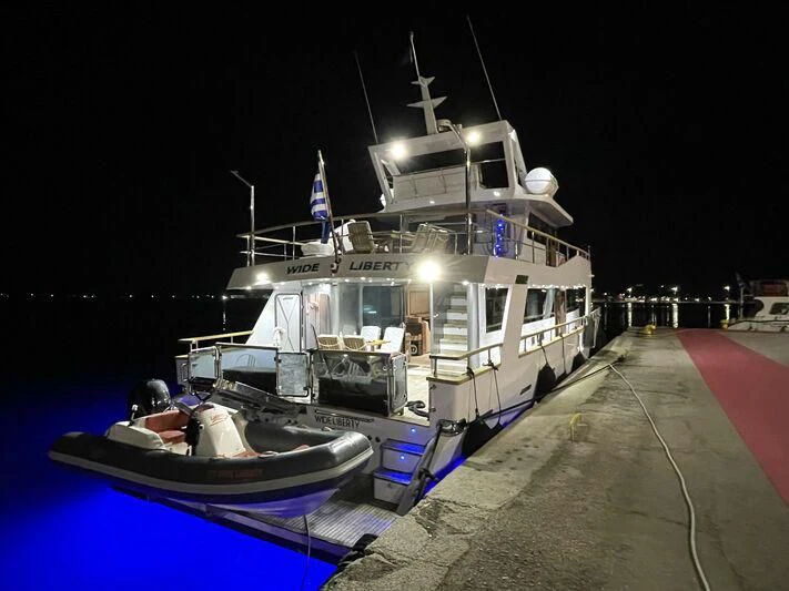 a large ship docked at night aboard WIDE LIBERTY Yacht for Sale