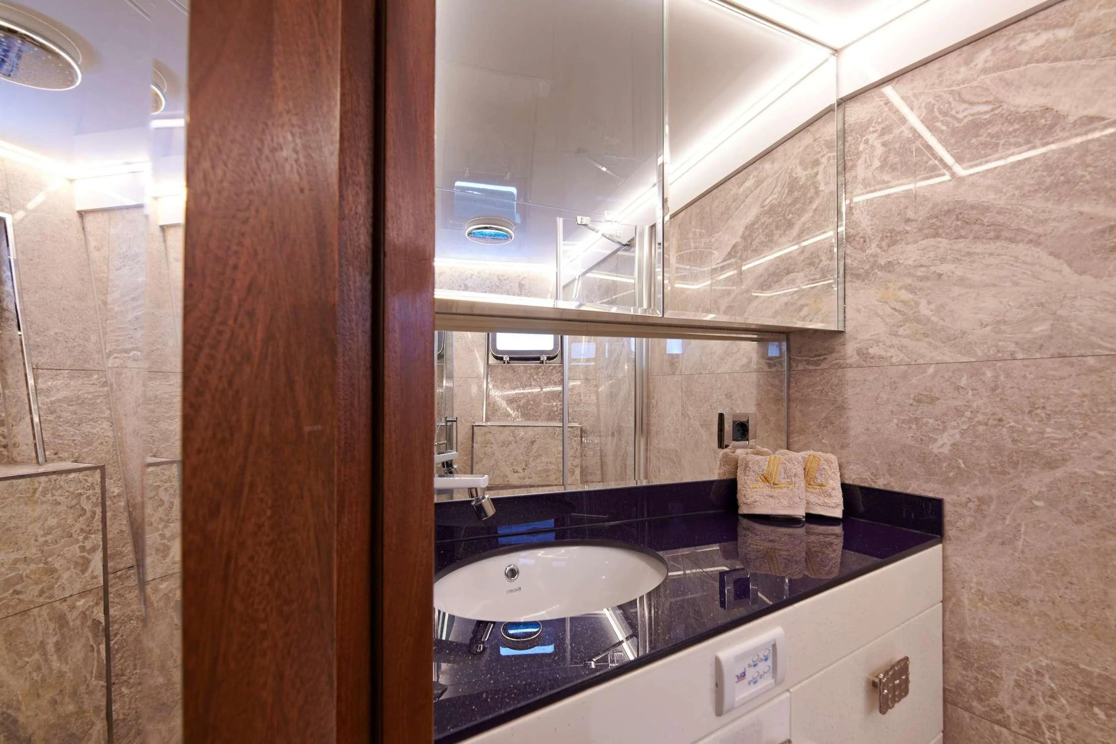 a bathroom with a sink and a mirror aboard WIDE LIBERTY Yacht for Sale