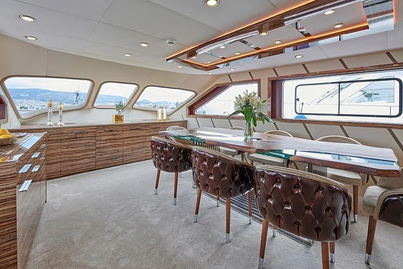 a room with a table and chairs aboard WIDE LIBERTY Yacht for Sale