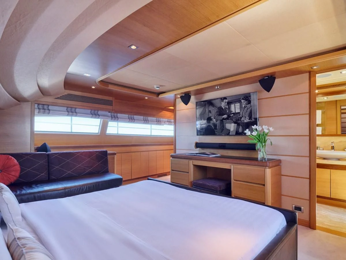 a bedroom with a bed and a desk aboard SEVEN S Yacht for Charter