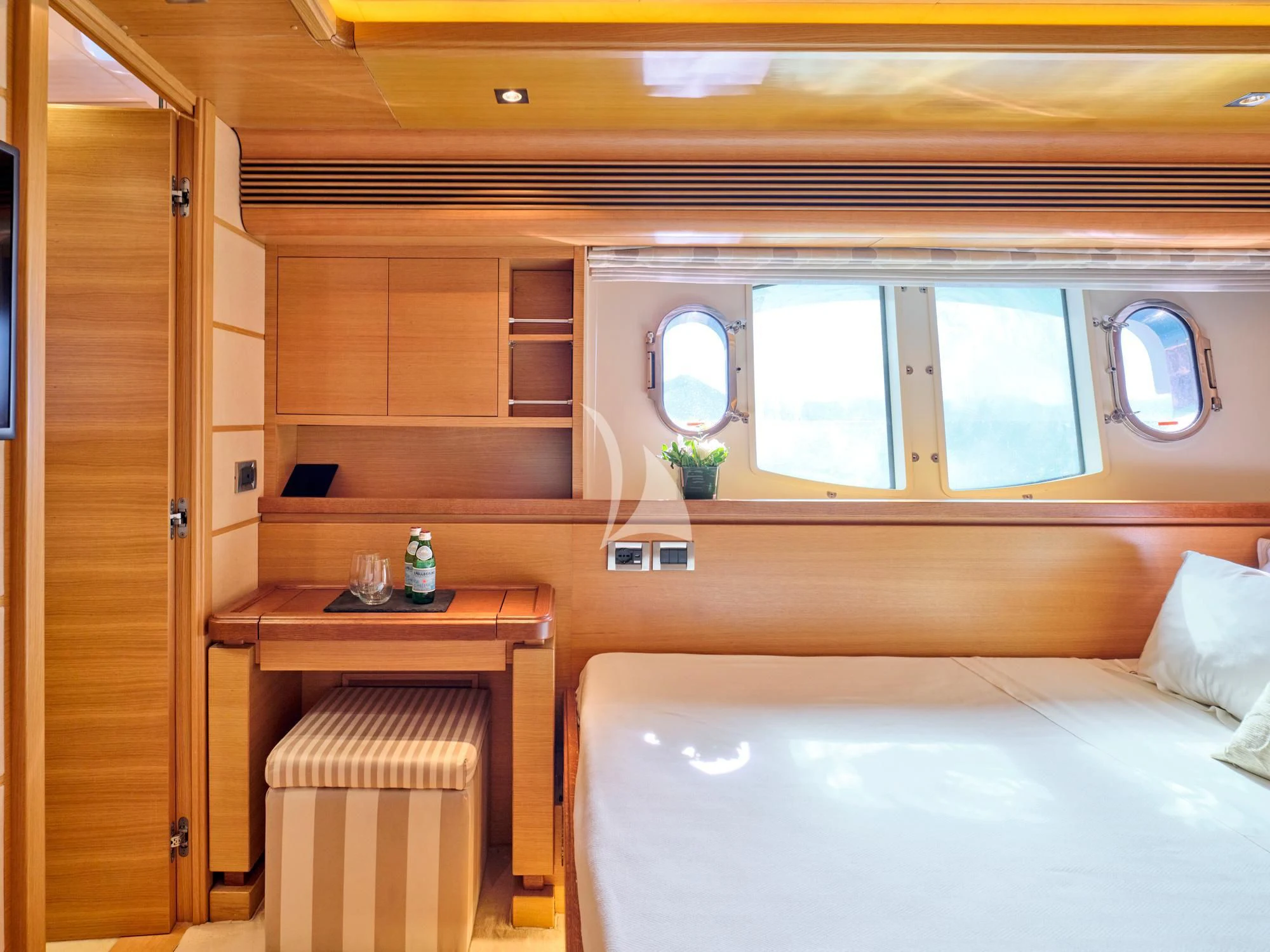 a room with a bed and a desk aboard SEVEN S Yacht for Charter