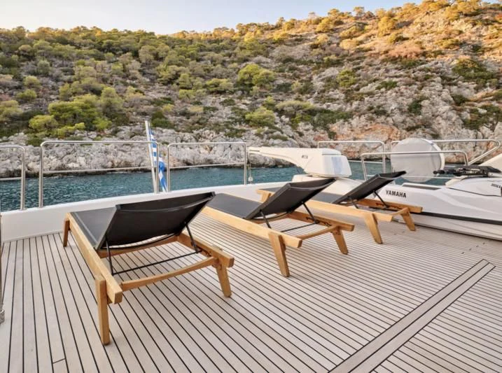 a deck with chairs and a table on it aboard SEVEN S Yacht for Charter
