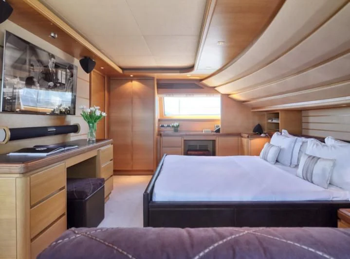 a bedroom with a bed and a desk aboard SEVEN S Yacht for Charter