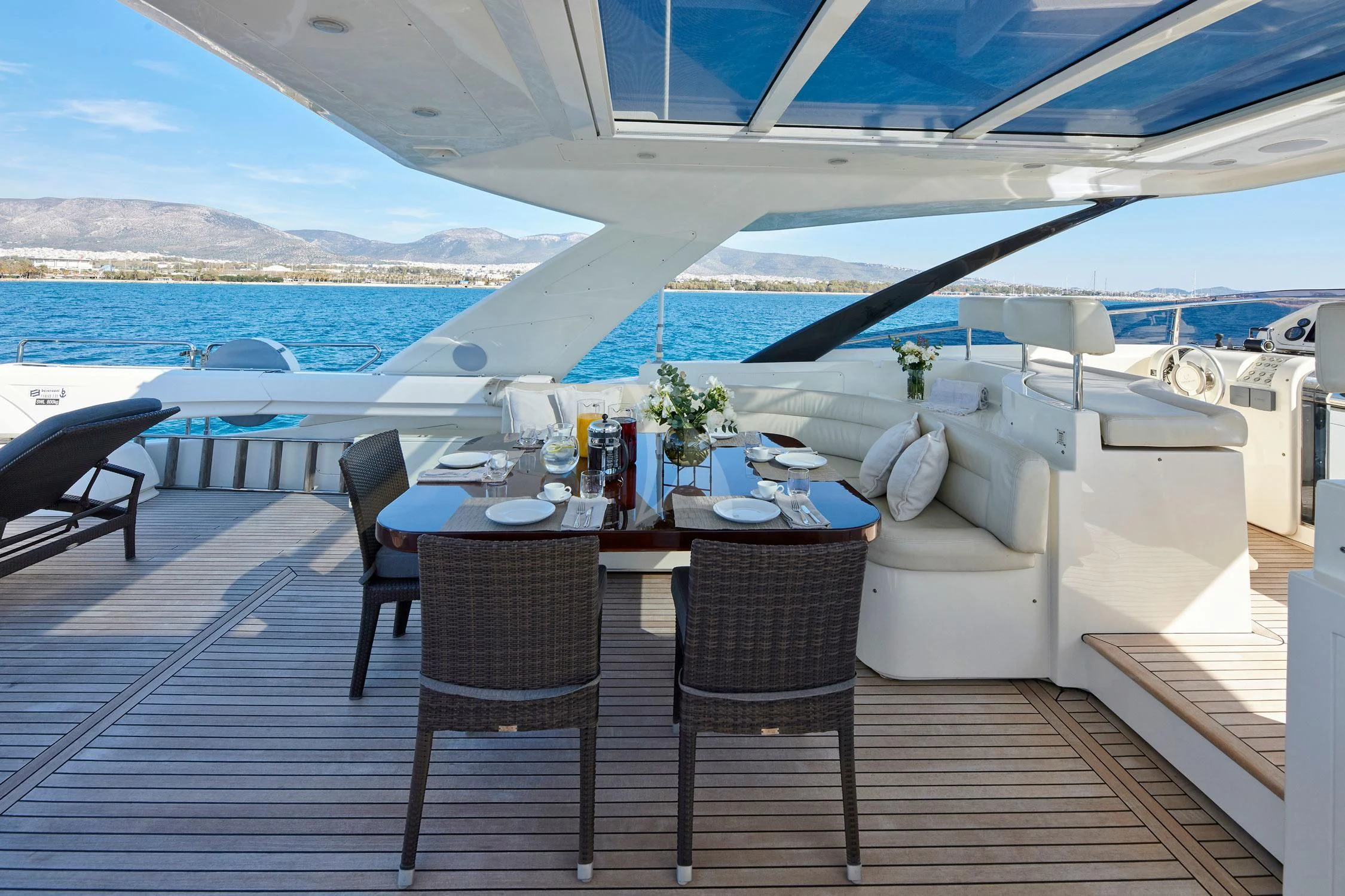 a table and chairs on a deck aboard SEVEN S Yacht for Charter