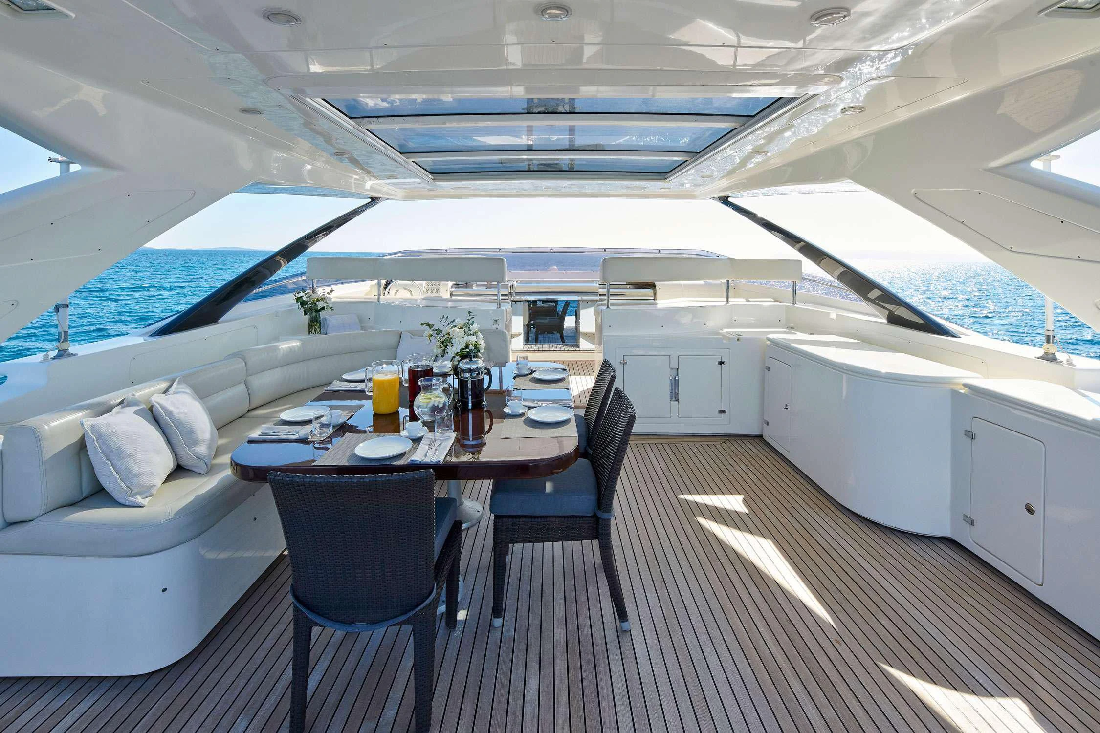 a boat with a table and chairs aboard SEVEN S Yacht for Charter