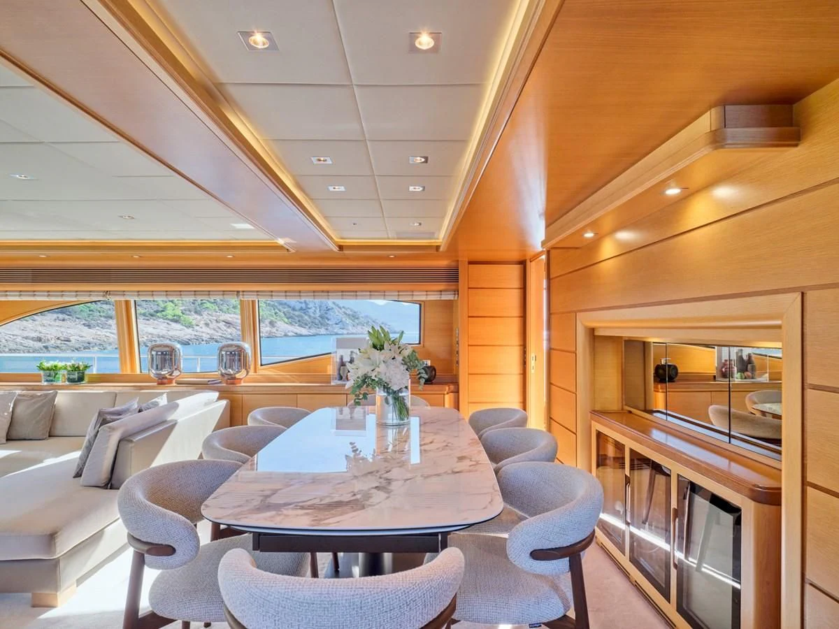 a room with a table and chairs aboard SEVEN S Yacht for Charter