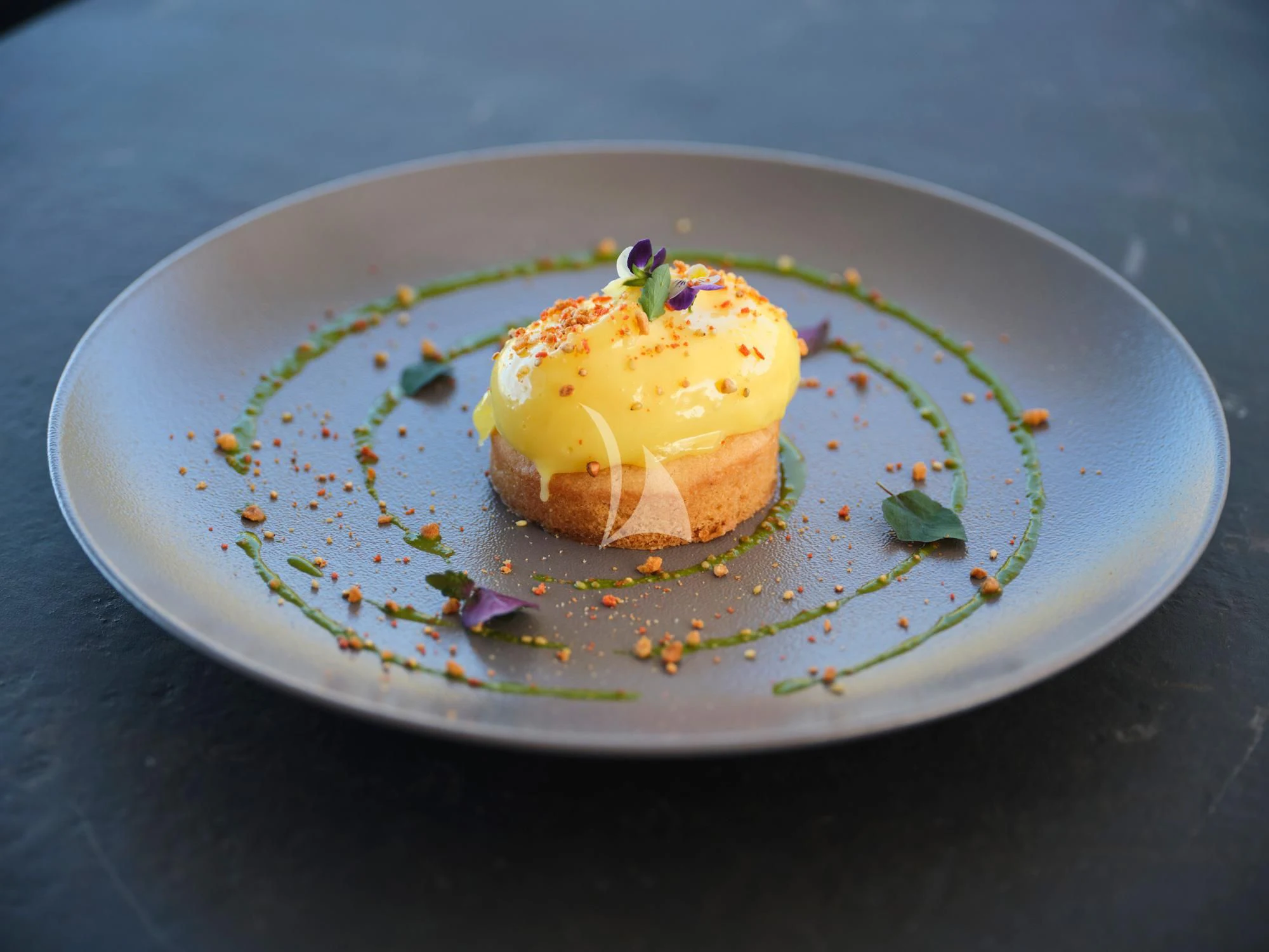 a piece of cake on a plate aboard SEVEN S Yacht for Charter