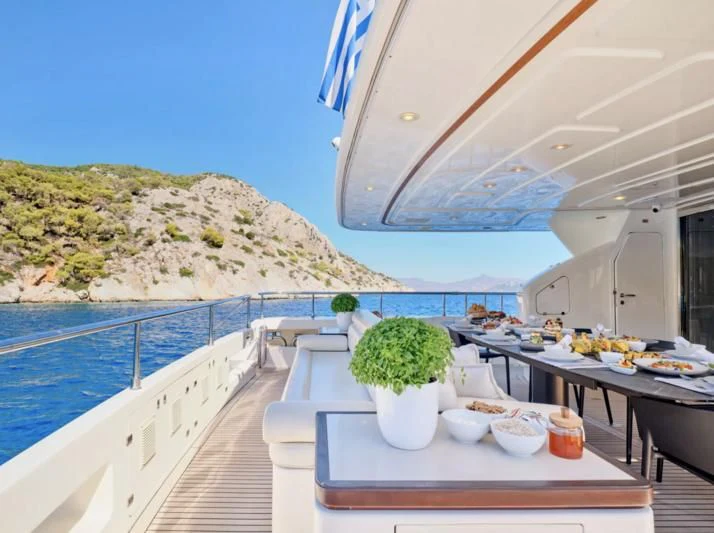 a table with food on it next to a pool of water aboard SEVEN S Yacht for Charter