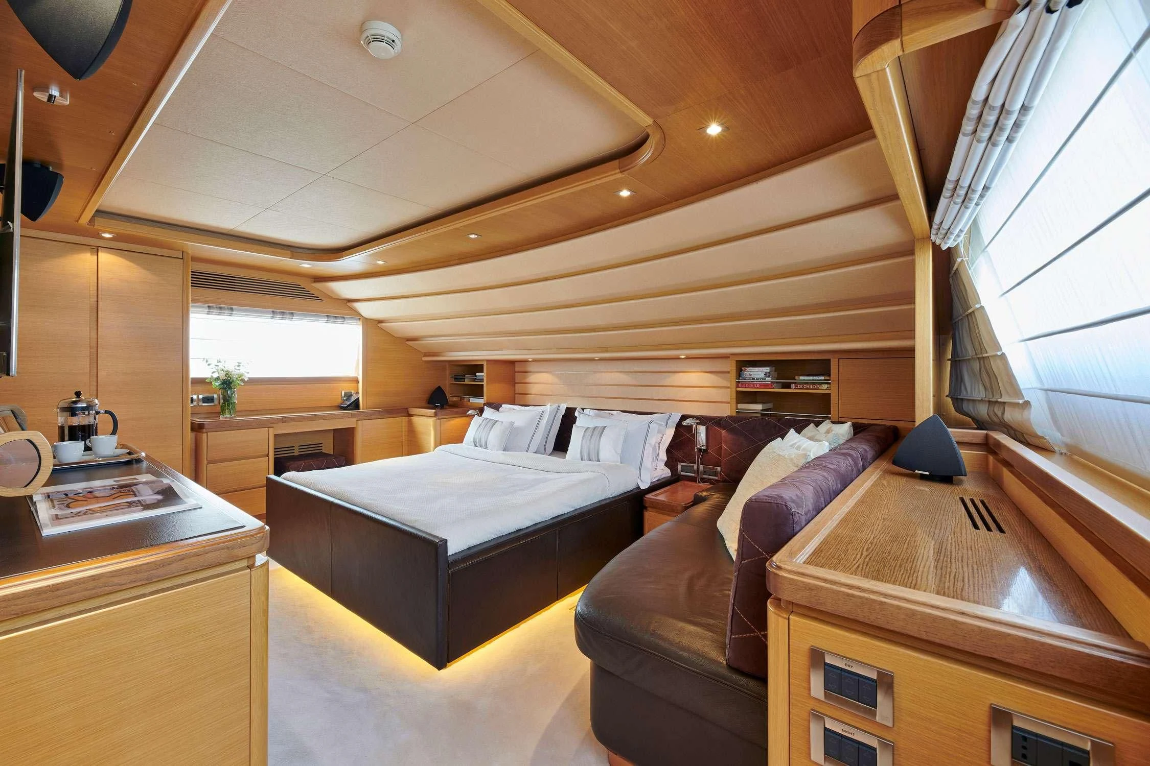 a bedroom with a bed and a couch aboard SEVEN S Yacht for Charter