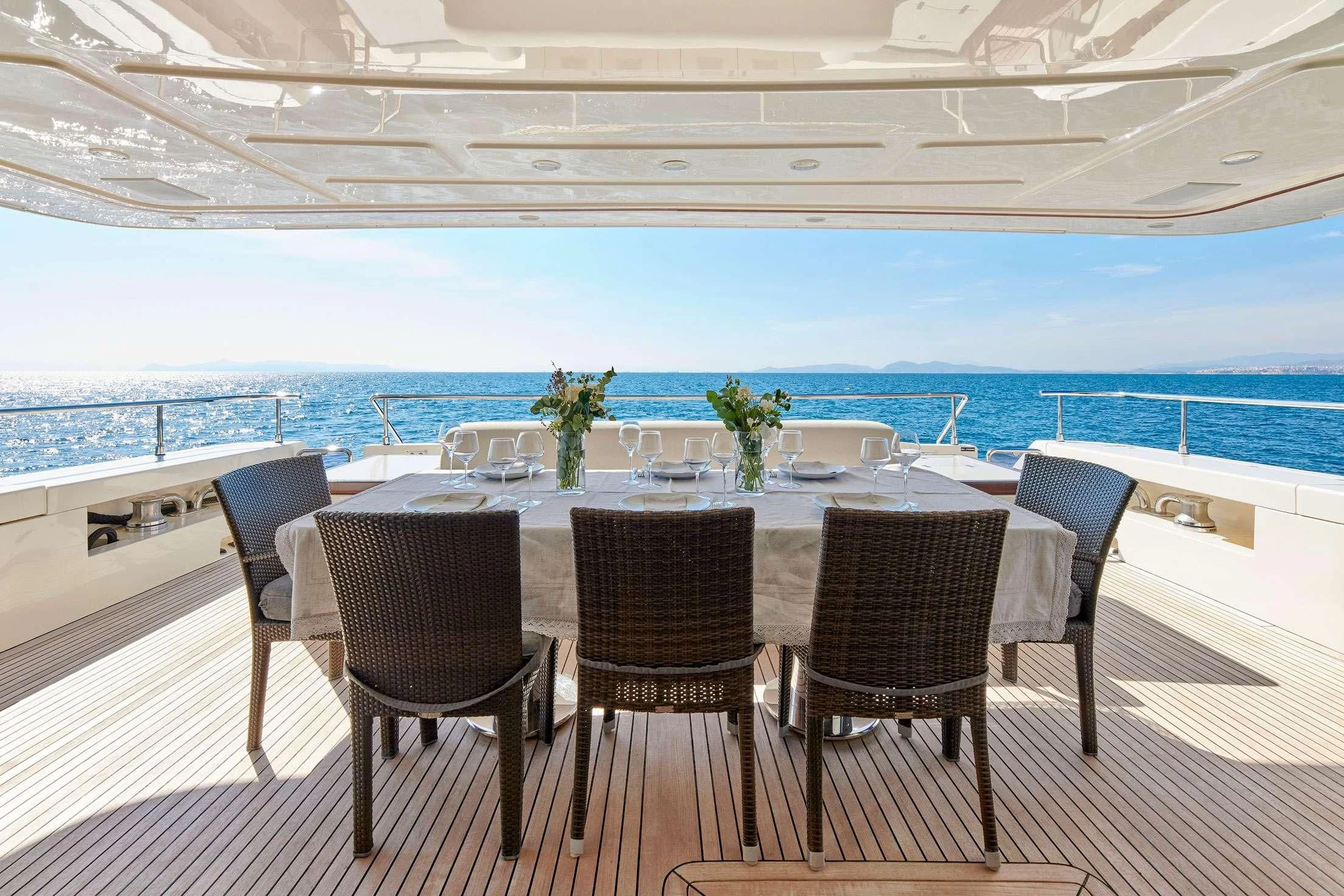 a table set for a dinner aboard SEVEN S Yacht for Charter