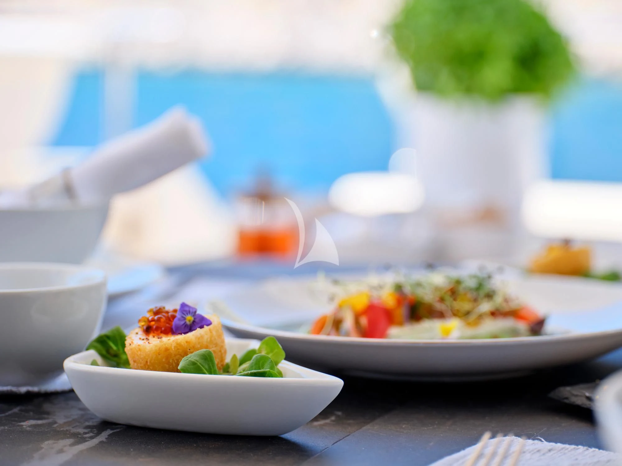 a table with plates of food aboard SEVEN S Yacht for Charter