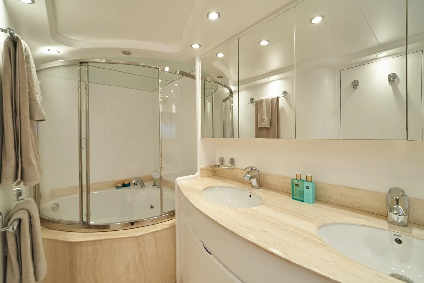 a bathroom with a shower sink and a mirror aboard KIAWAH II Yacht for Sale