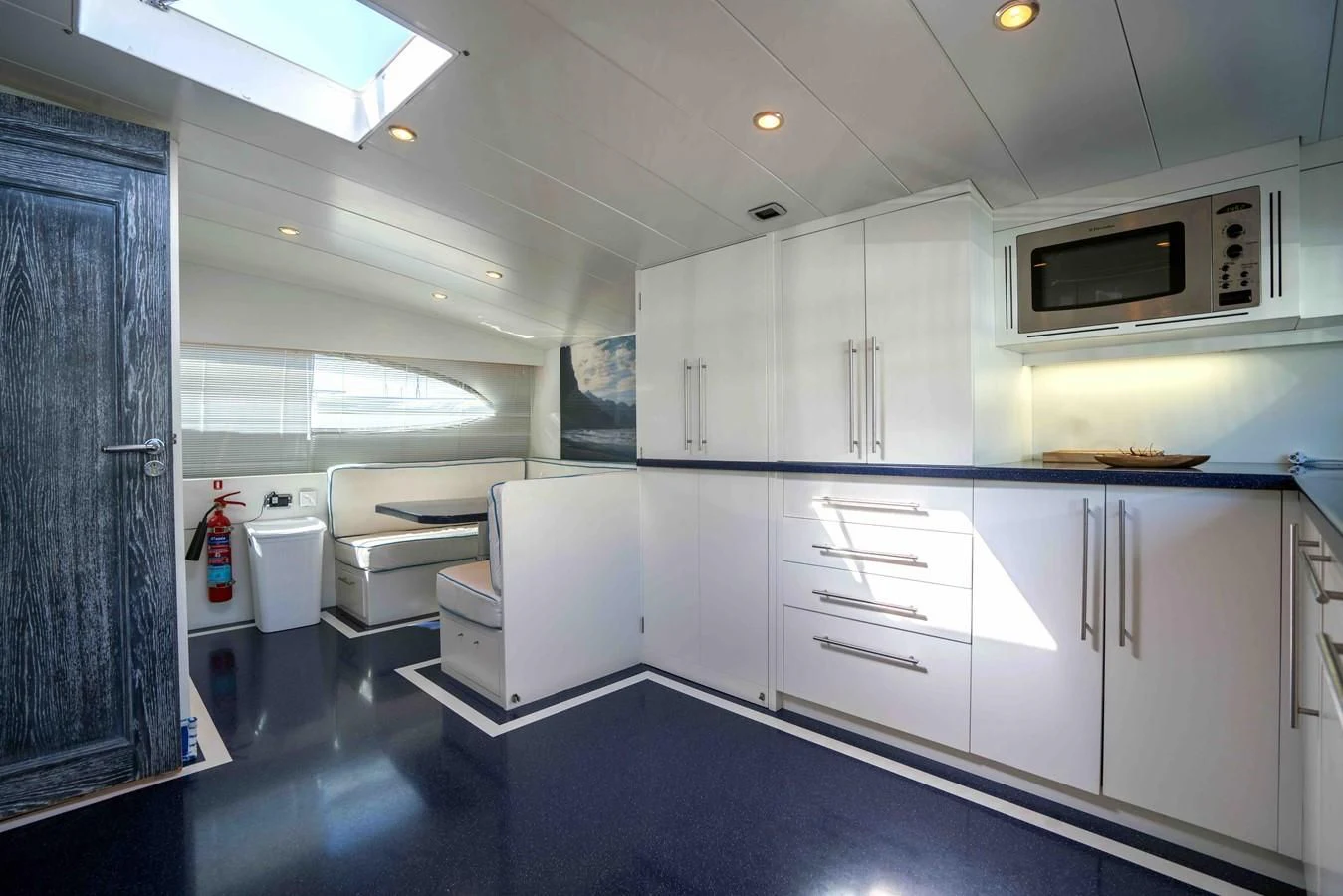 a kitchen with white cabinets aboard KIAWAH II Yacht for Sale