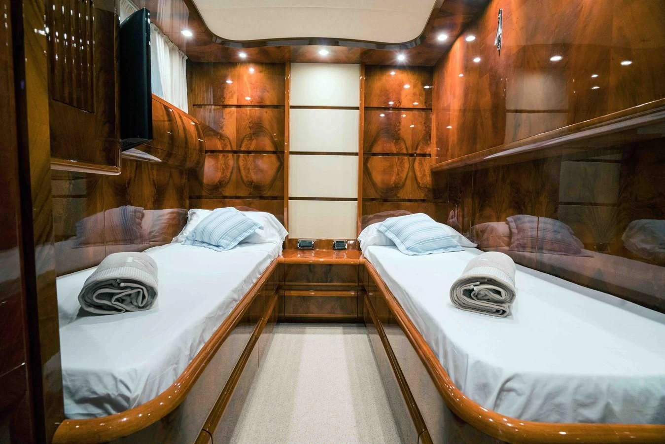 a room with beds and a mirror aboard KIAWAH II Yacht for Sale