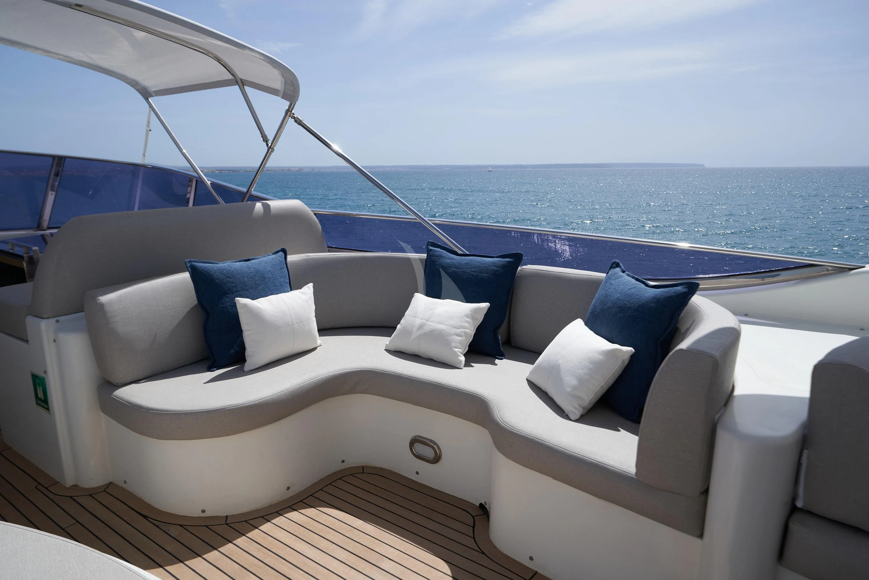 a white couch with pillows on it aboard KIAWAH II Yacht for Sale