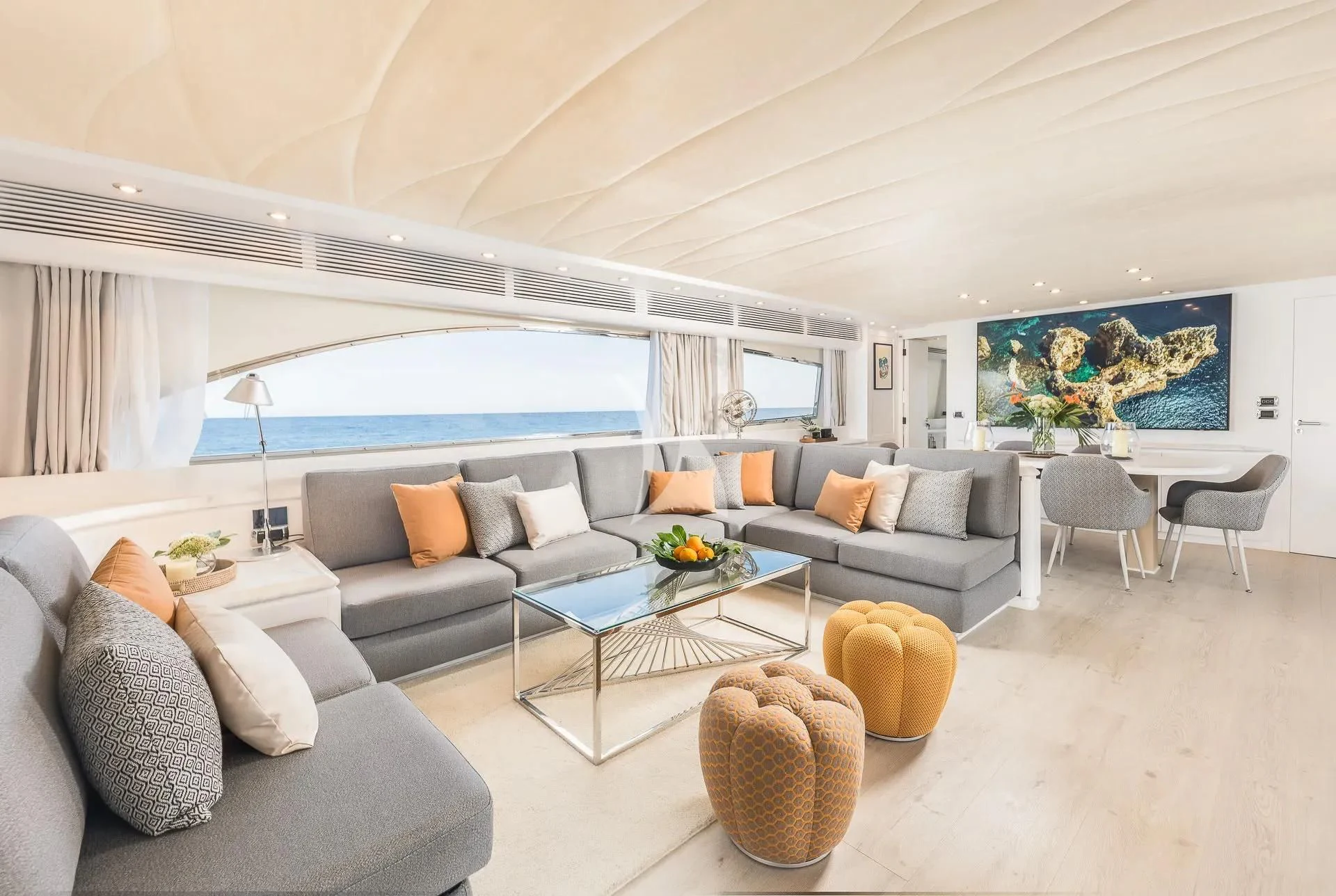 a living room with a large blue glass window aboard KIAWAH II Yacht for Sale