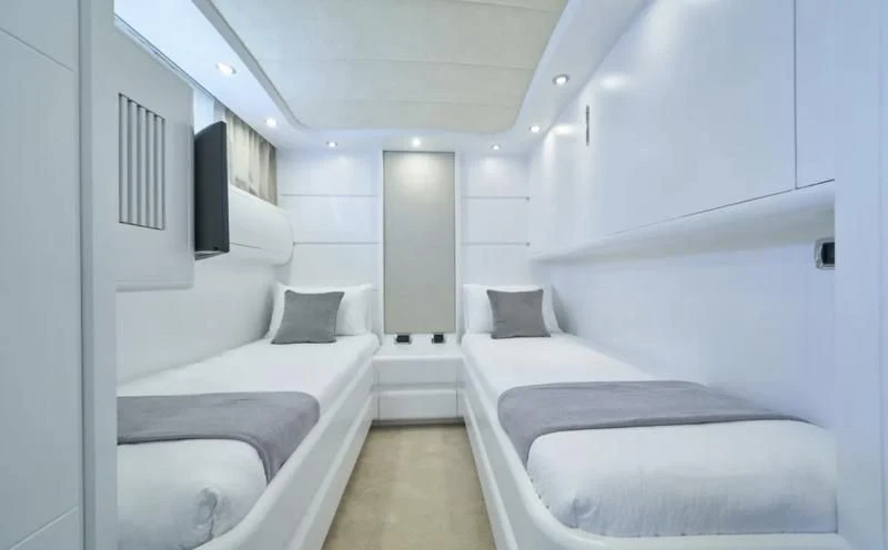 a room with white beds aboard KIAWAH II Yacht for Sale