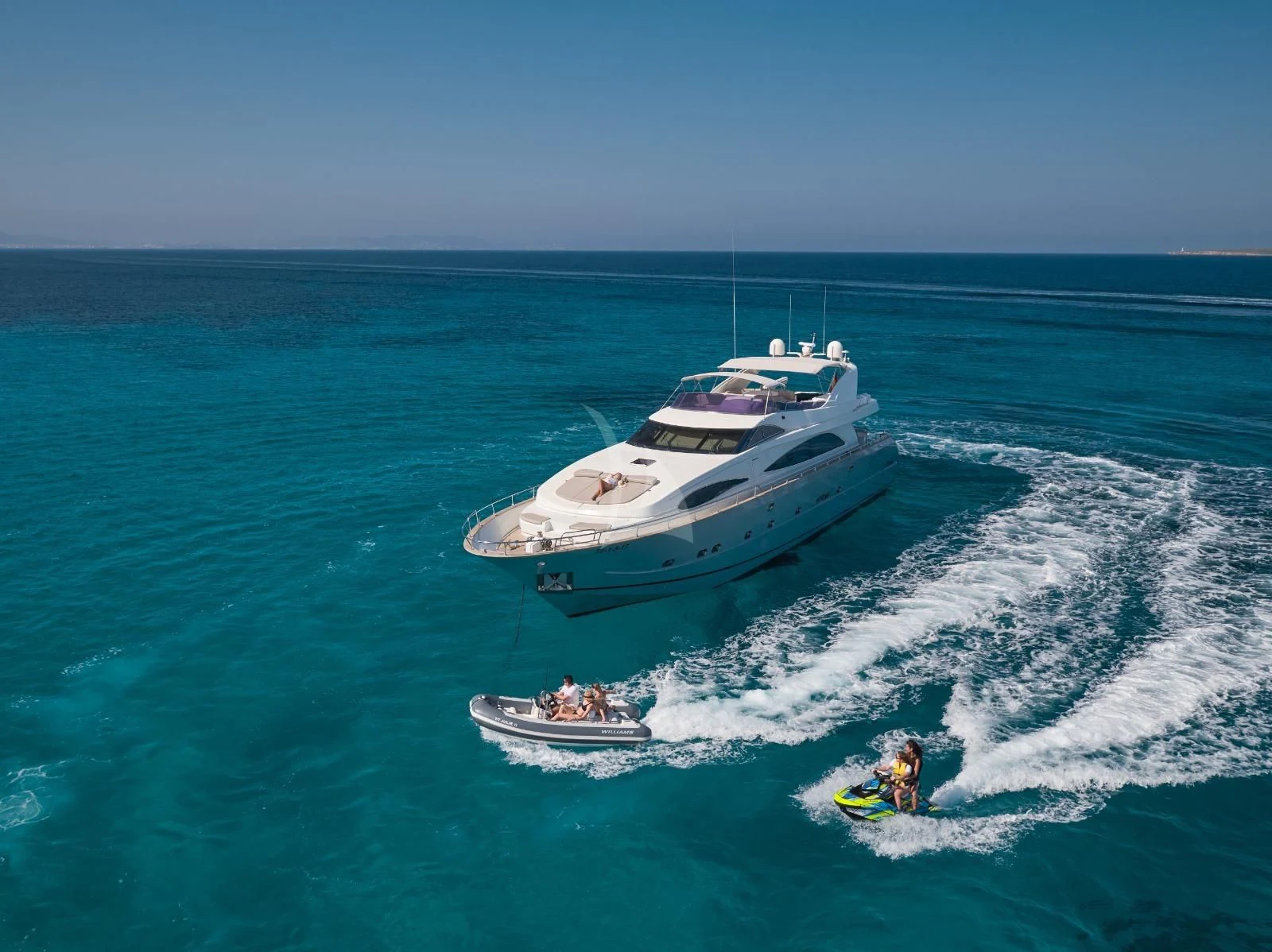 a boat and a couple of people in the water aboard KIAWAH II Yacht for Sale