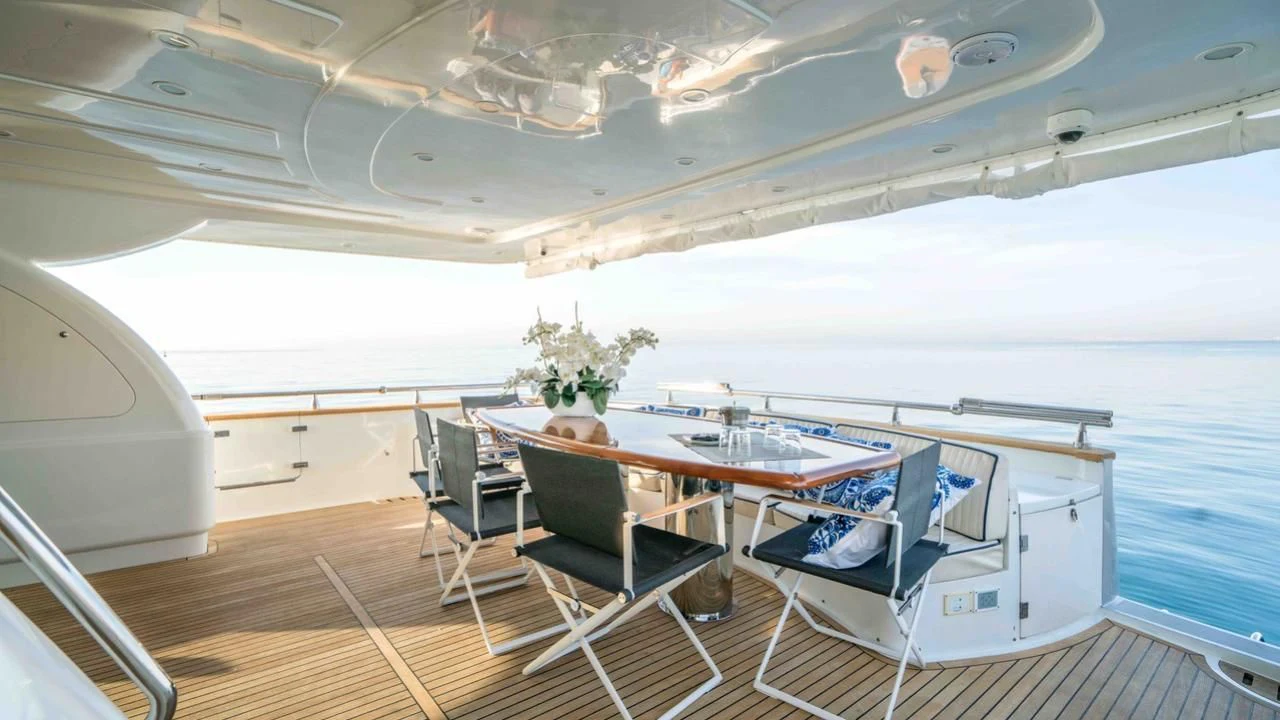 a room with a table and chairs aboard KIAWAH II Yacht for Sale