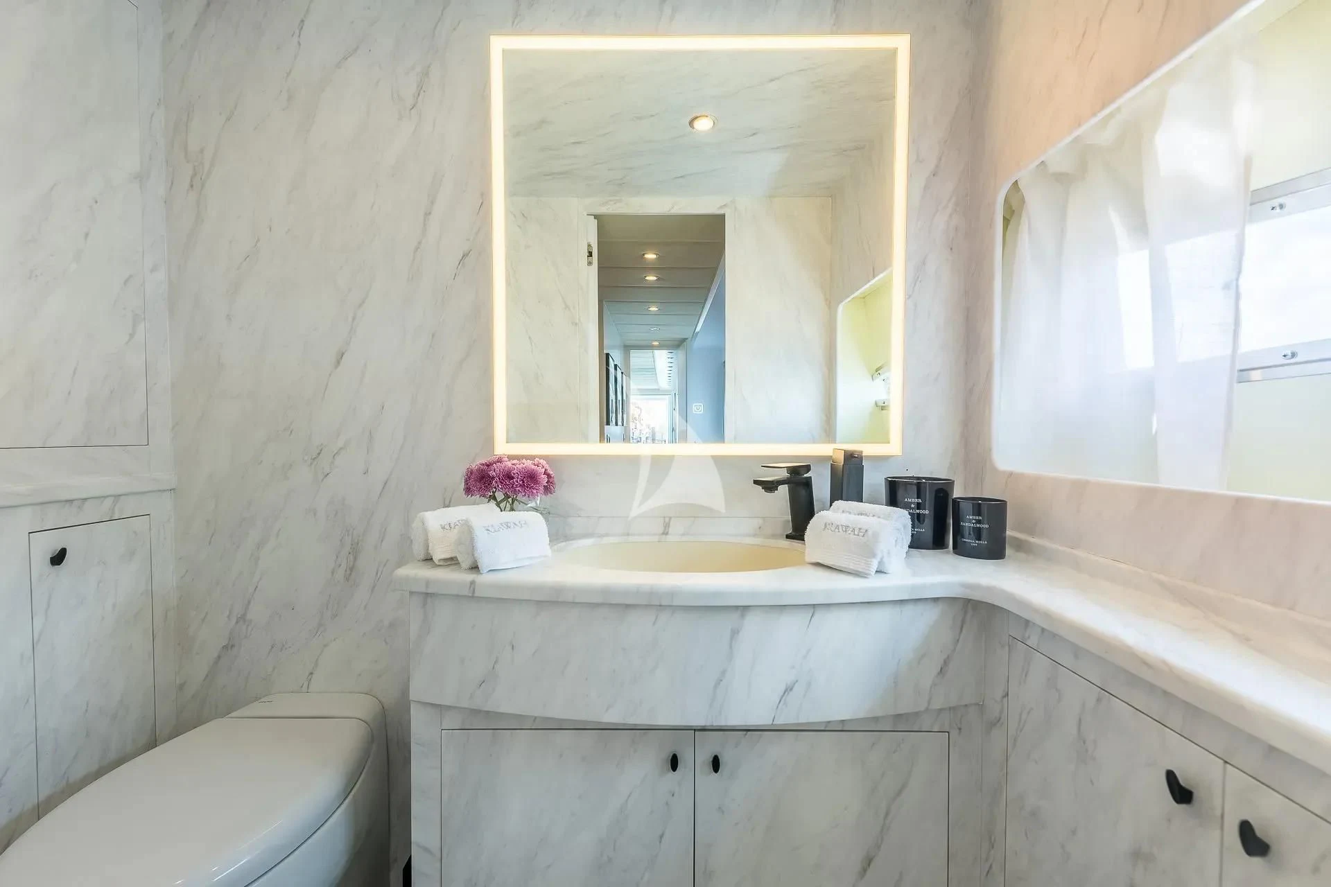 a bathroom with a large mirror aboard KIAWAH II Yacht for Sale