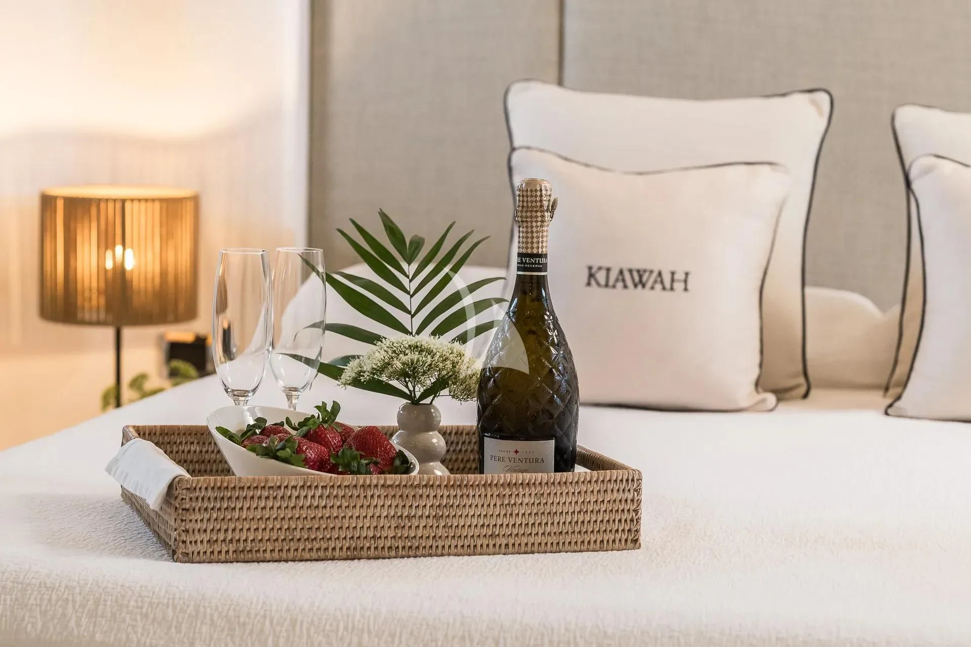 a table with a plate of food and a bottle of wine aboard KIAWAH II Yacht for Sale