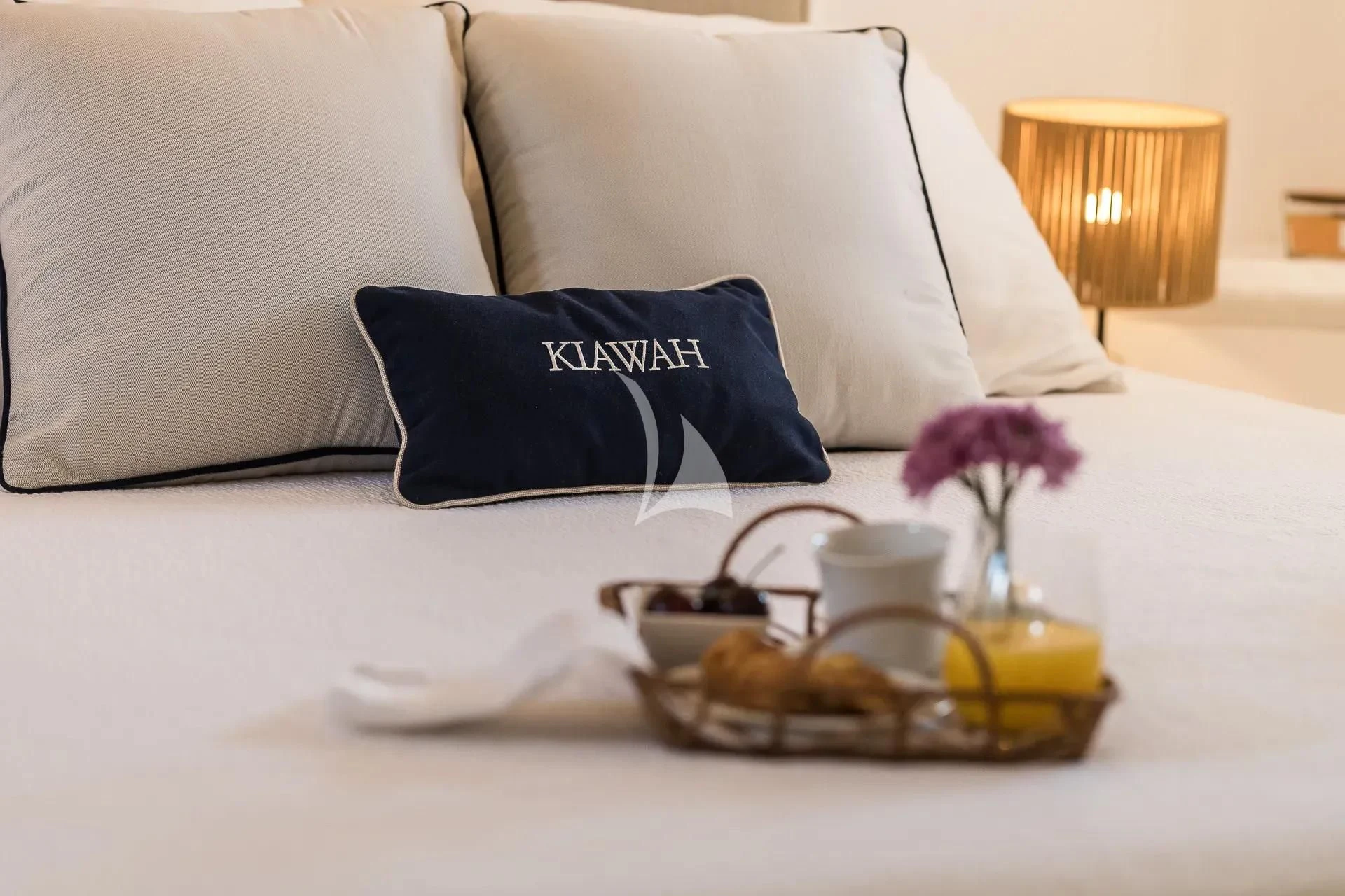 a tray of food and a glass of juice on a table aboard KIAWAH II Yacht for Sale