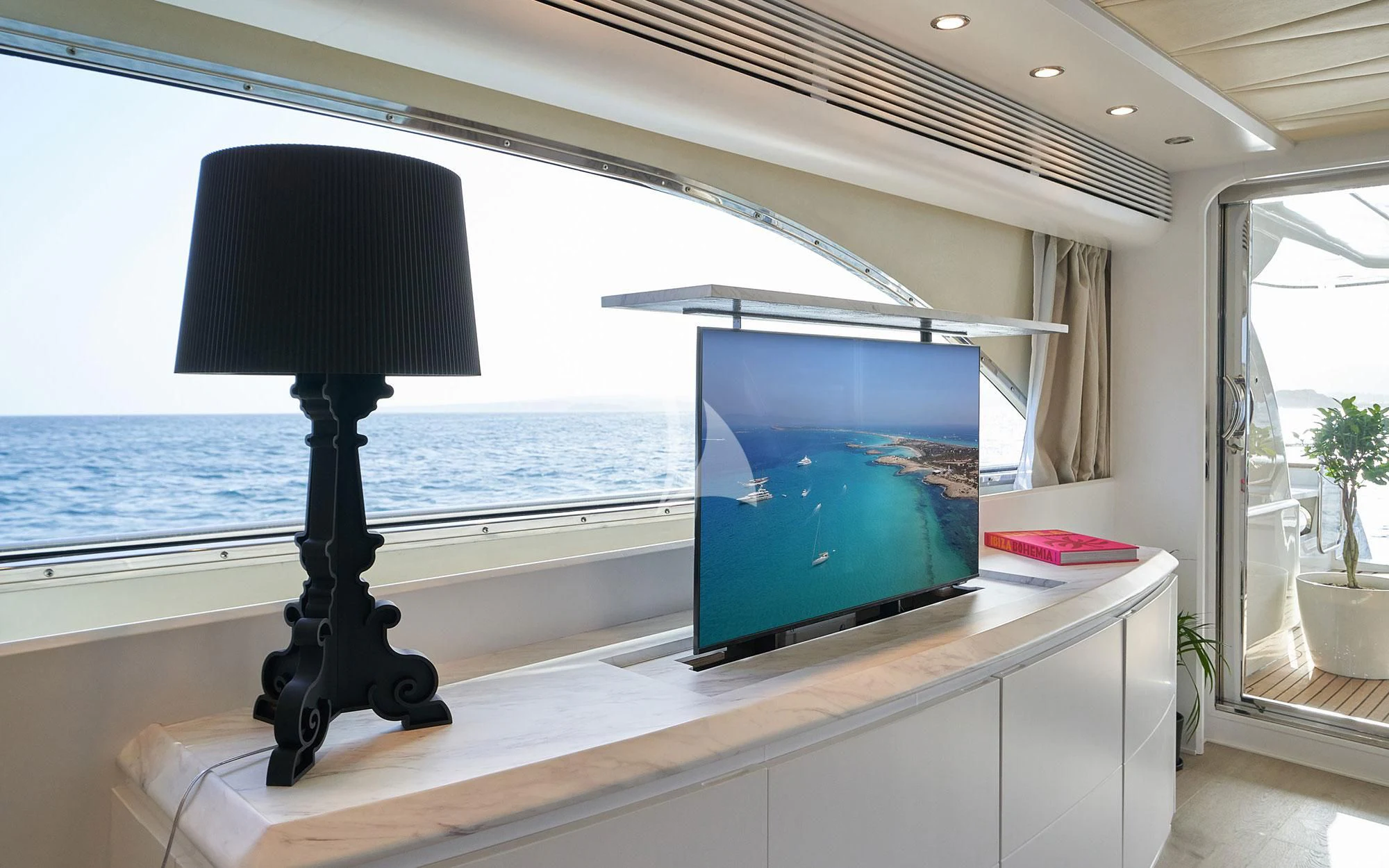 a desk with a lamp and a television on it aboard KIAWAH II Yacht for Sale
