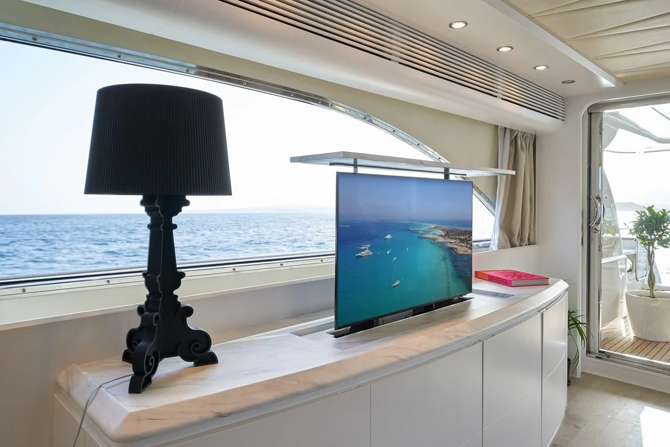 a desk with a lamp and a computer on it aboard KIAWAH II Yacht for Sale