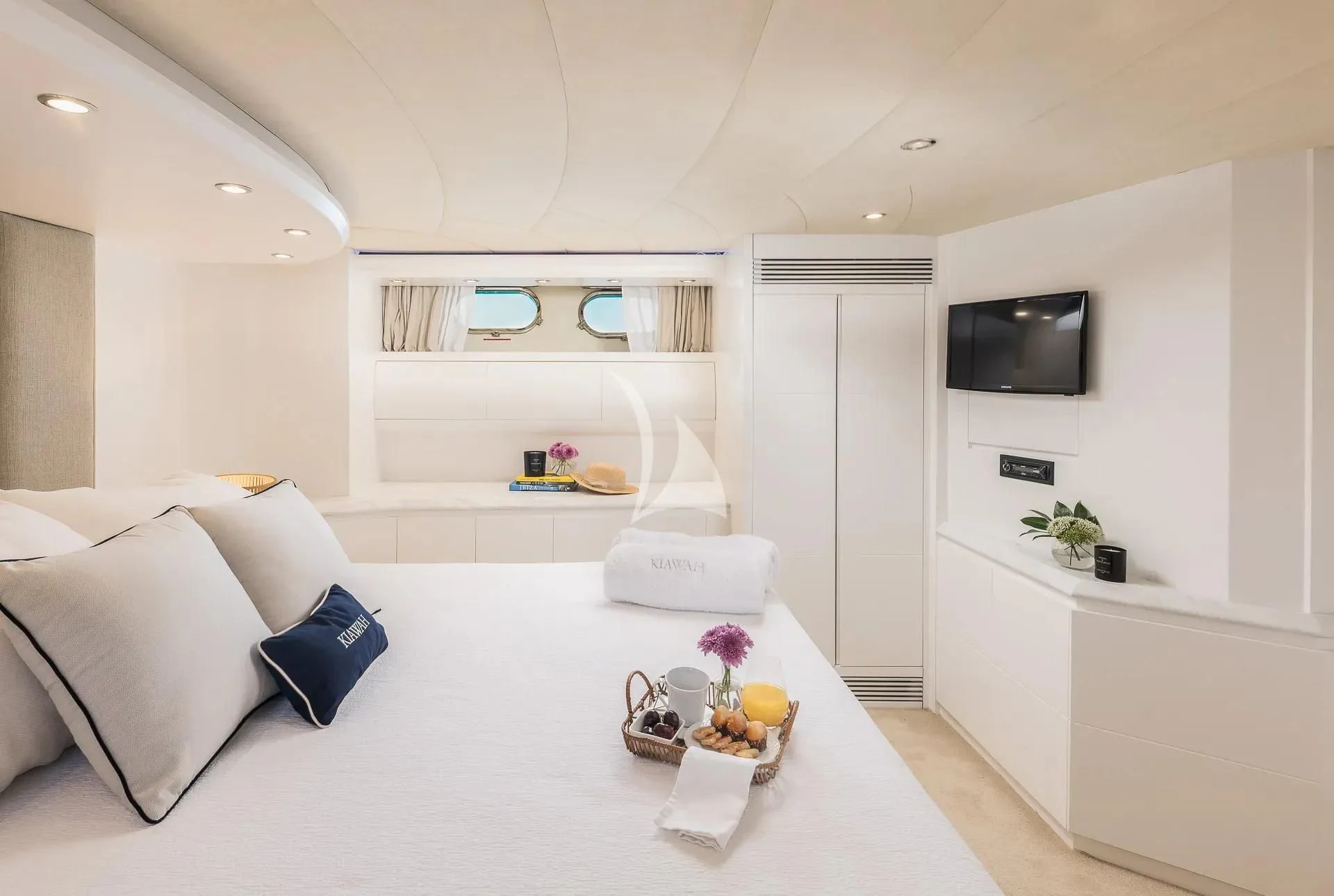 a white living room with a white couch and a white wall aboard KIAWAH II Yacht for Sale