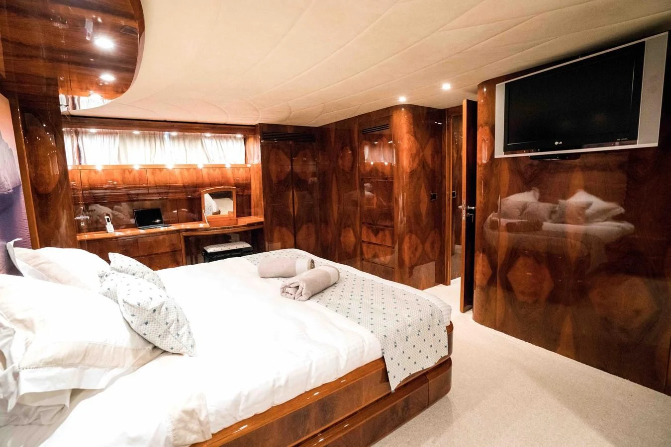 a room with a bed and a television aboard KIAWAH II Yacht for Sale