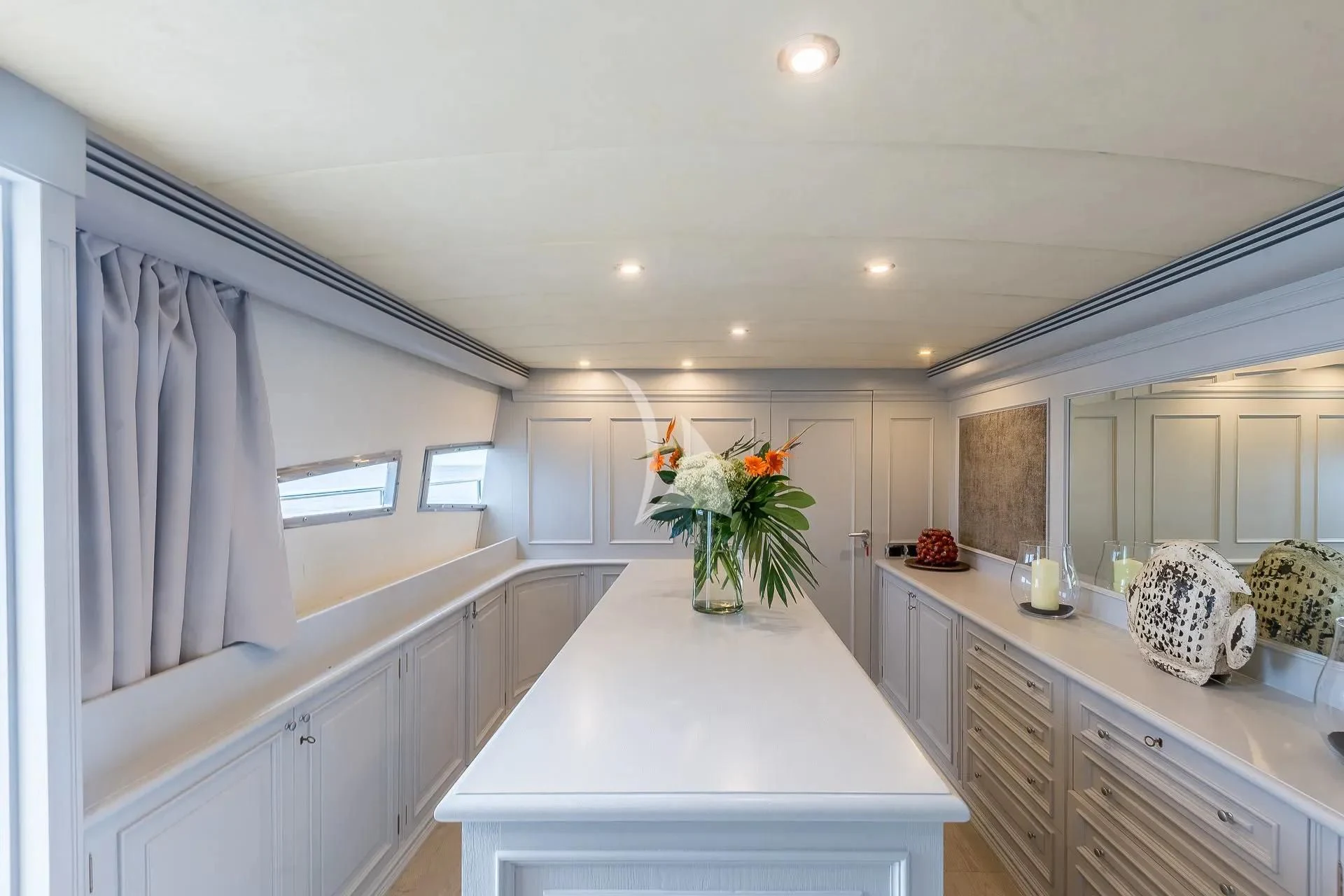 a kitchen with white cabinets aboard KIAWAH II Yacht for Sale