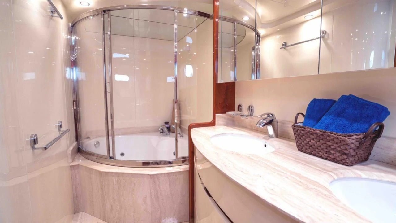 a bathroom with a tub sink and a mirror aboard KIAWAH II Yacht for Sale