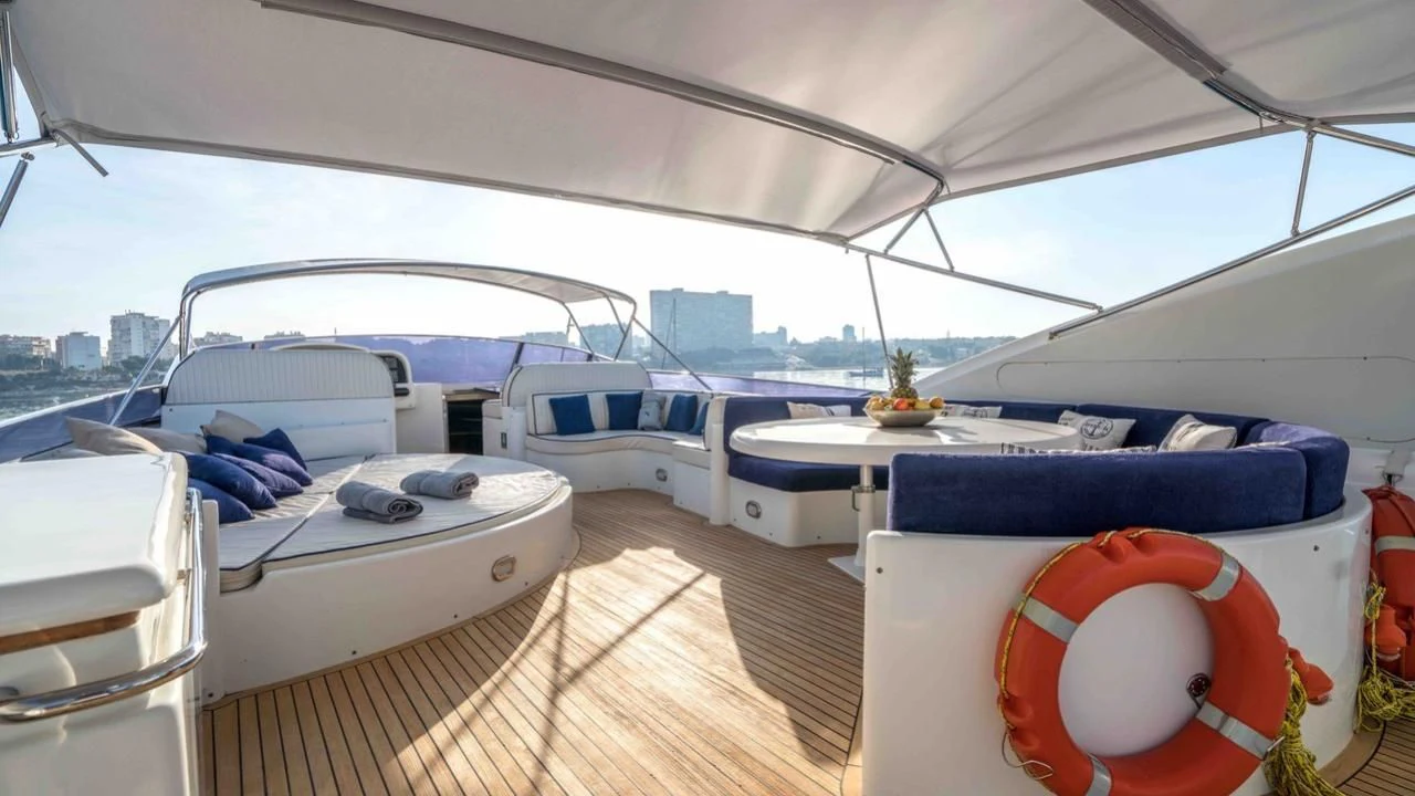 a boat with a deck and a table and chairs on a deck aboard KIAWAH II Yacht for Sale