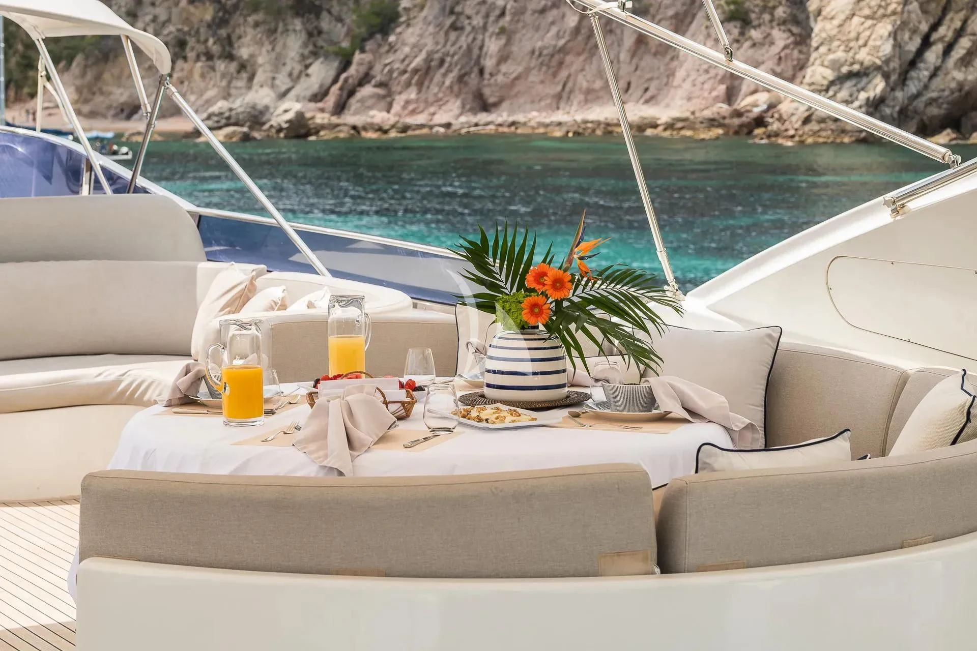 a table with a plate of food and drinks on it aboard KIAWAH II Yacht for Sale